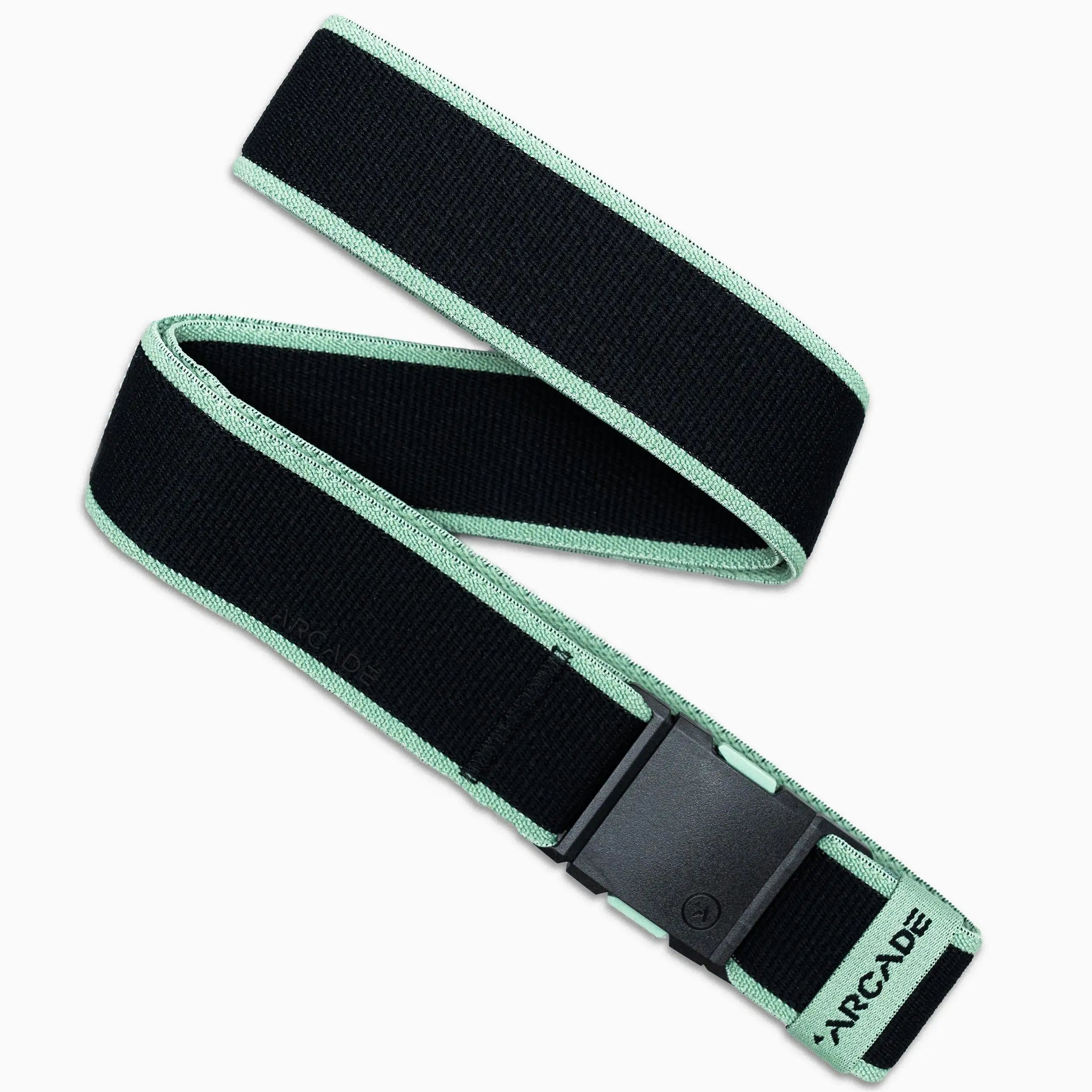 The Arcade Belts Carto is a black elastic stretch belt with light green edges, a black plastic buckle, and ARCADE printed near the end. It’s displayed in a loose loop on a white background.