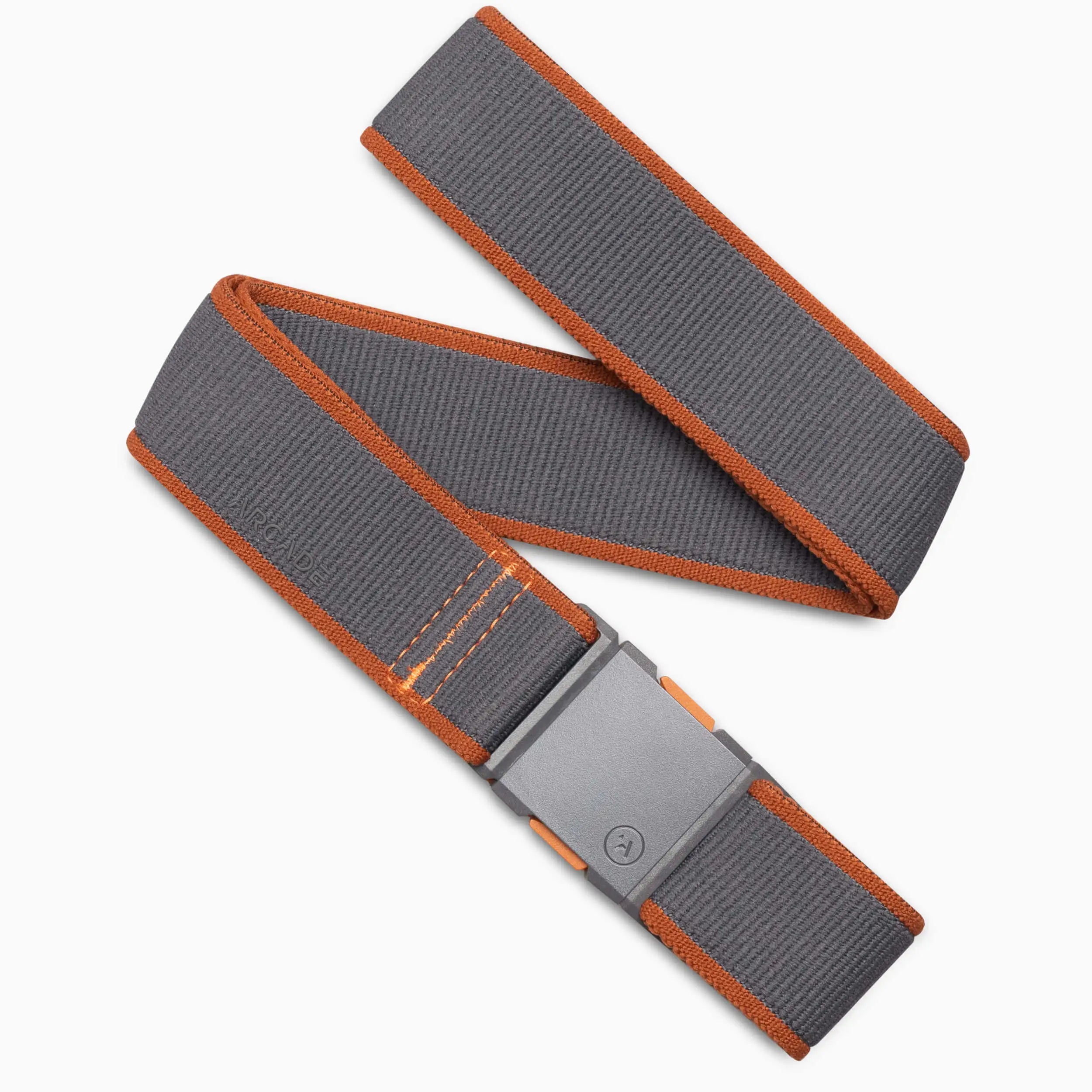 The Carto by Arcade Belts is a gray stretch webbing belt with orange edges and stitching, featuring a rectangular gray buckle with orange accents—ideal for travel. Shown on a white background.