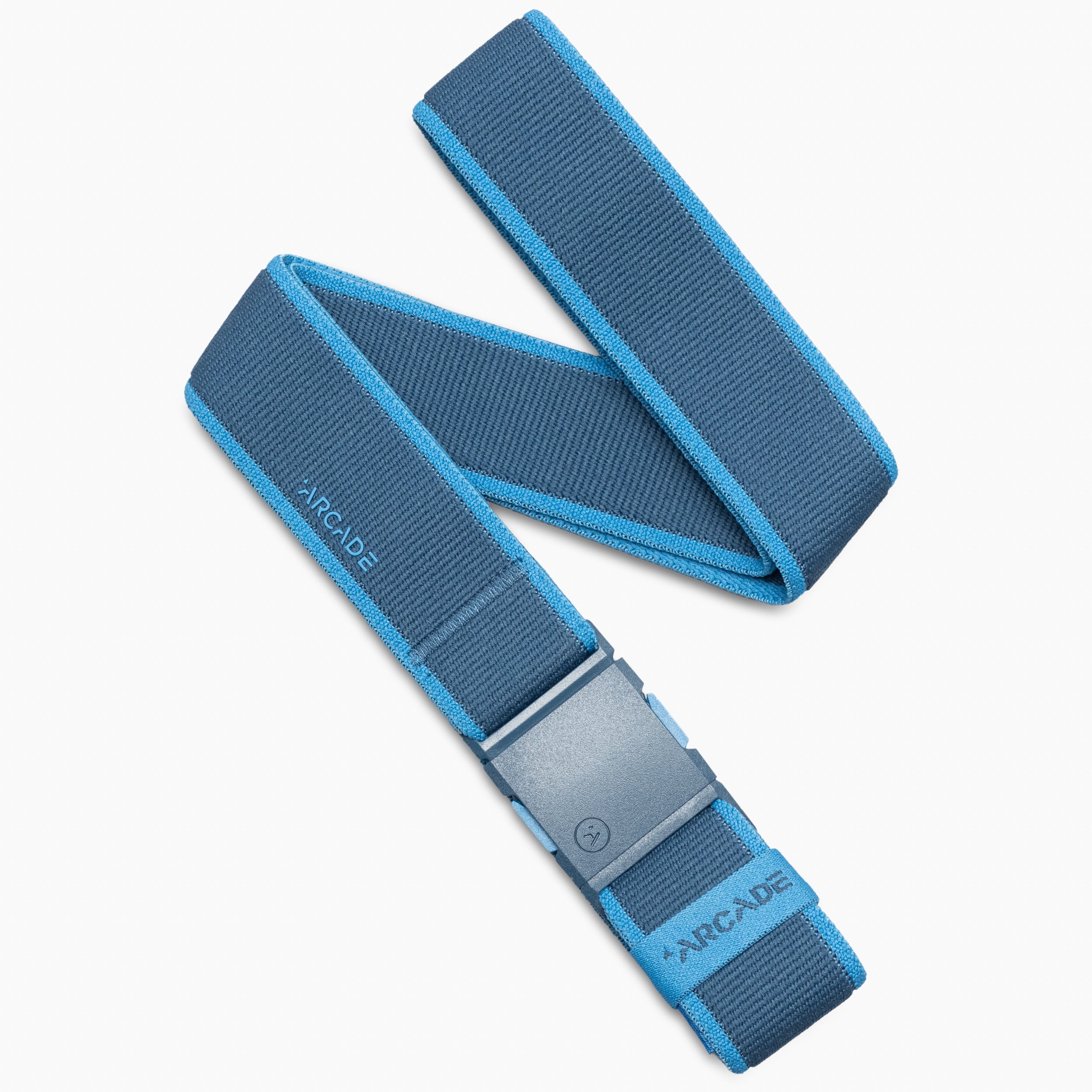 The Carto belt by Arcade Belts features a blue performance stretch fabric with lighter blue trim and a darker blue buckle. “ARCADE” is printed on the strap and near the buckle, and it is displayed in a zigzag arrangement on a white background—making it an adventurous accessory.