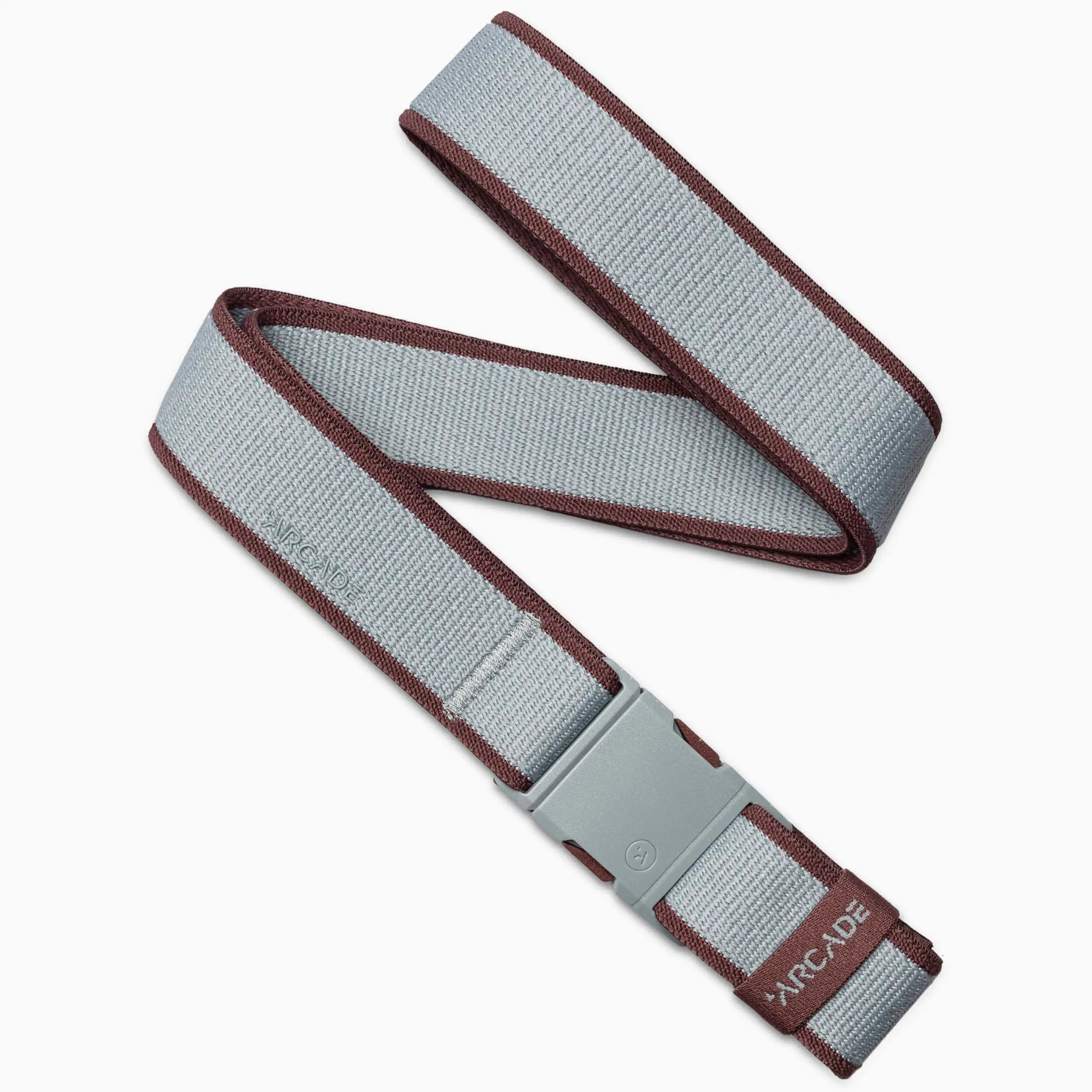 A gray Carto belt by Arcade Belts with maroon edges, a gray plastic buckle, and ARCADE branding at the end. Made from stretch webbing and shown loosely folded.