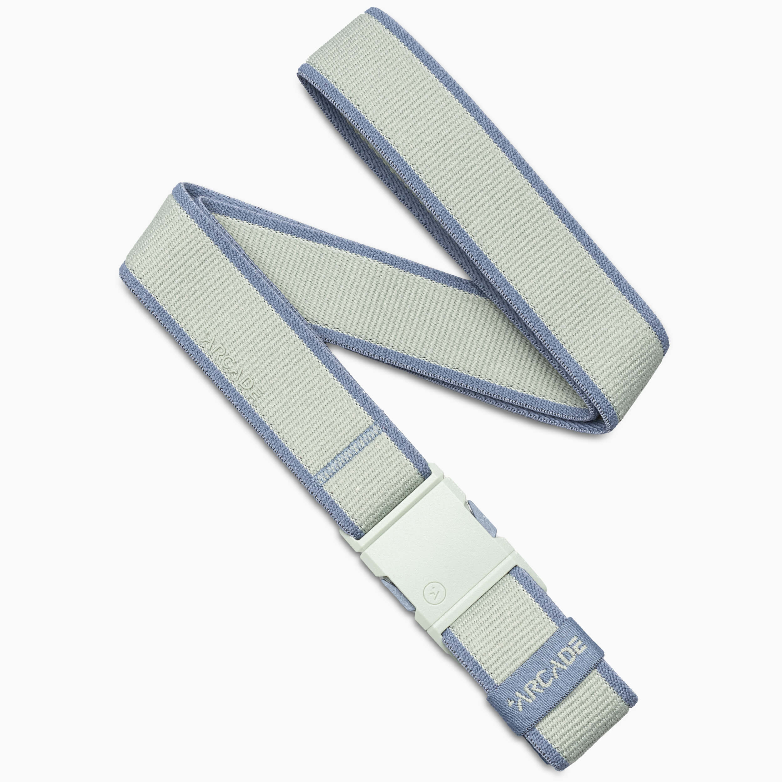 A light gray Arcade Belts Carto adventure belt with blue edges, white clasp buckle, and “ARCADE” embroidered near the tip is loosely coiled on a white background.