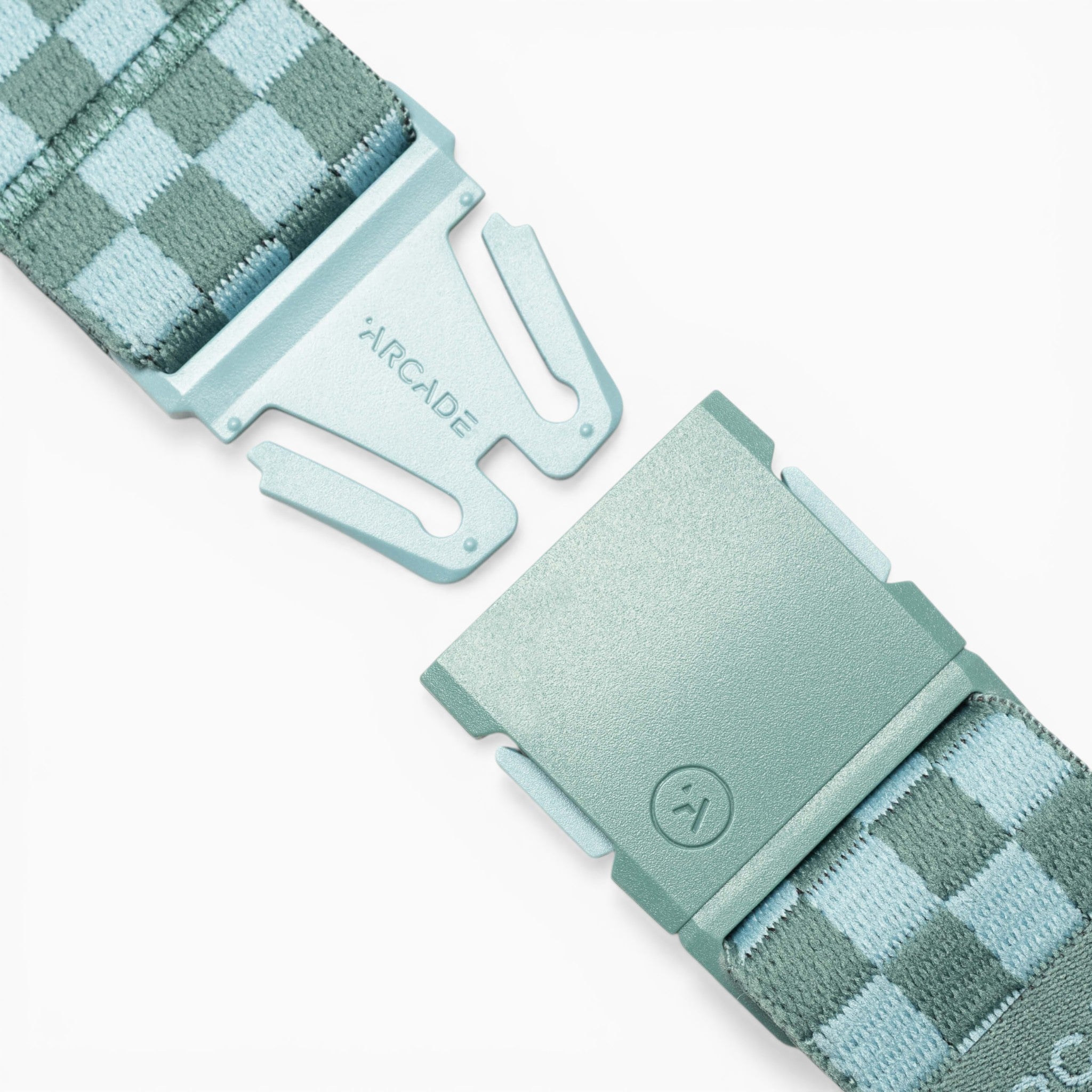 Close-up of the Arcade Belts Check, a blue checkered belt with a metal clasp labelled ARCADE, displayed with its two ends slightly apart on a white background. Designed for performance stretch and made for movement, this stylish accessory from Arcade Belts turns heads wherever you go.