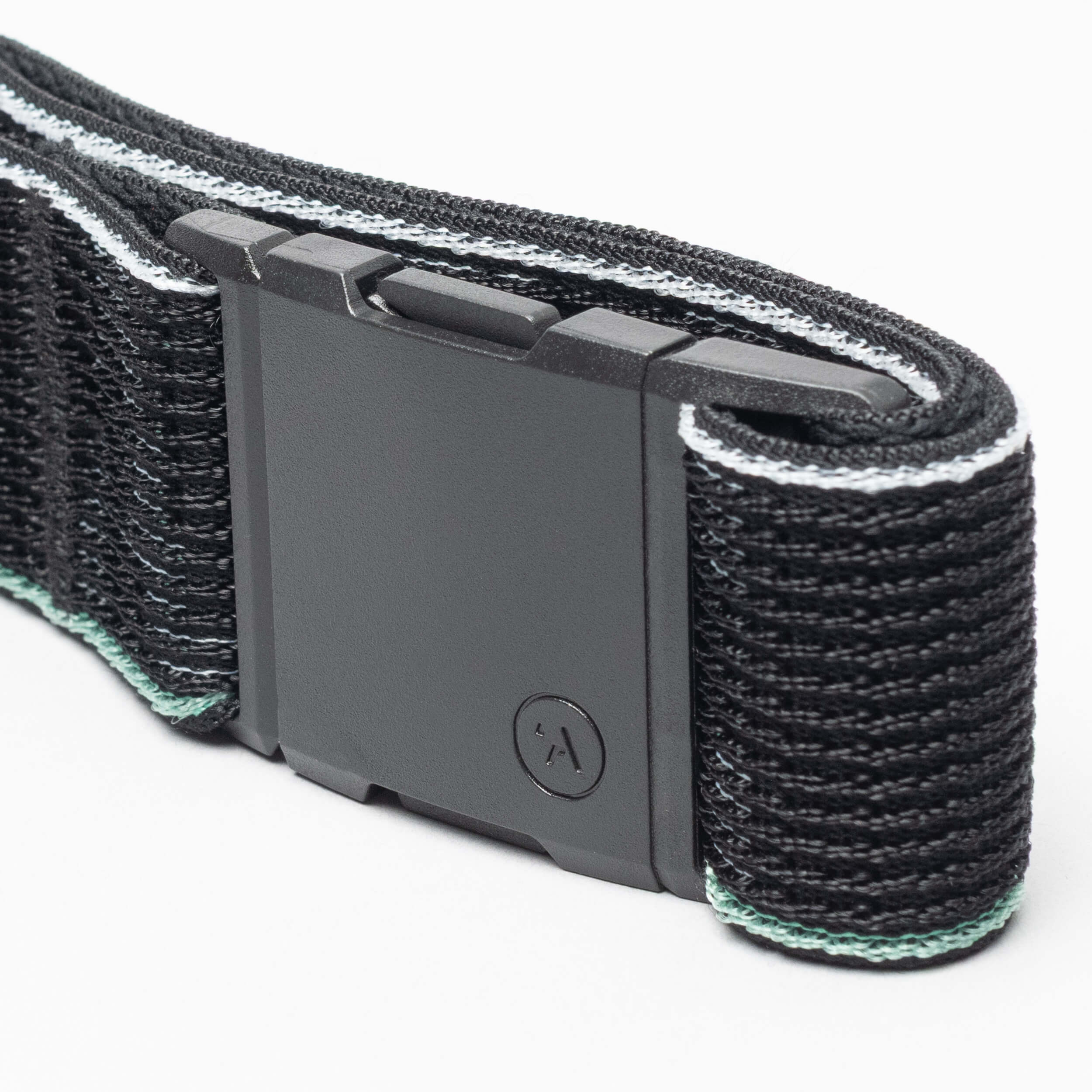 A close-up of the Arcade Belts Cubed: a black woven fabric belt with a matte black rectangular buckle and comfortable design, featuring light blue and white trim along the edges.