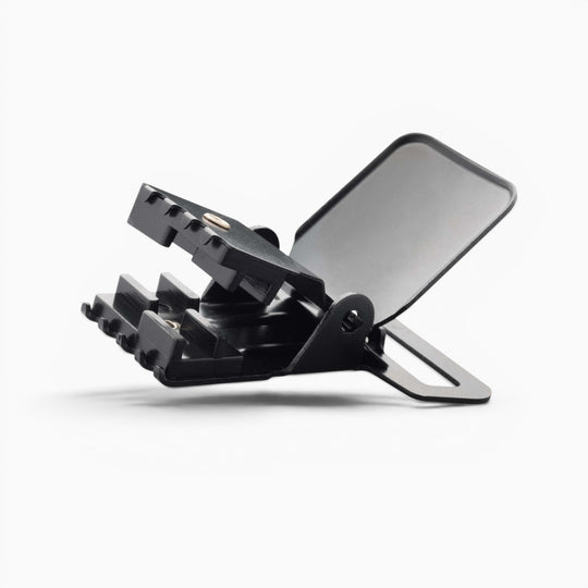 A black plastic Jessup clip by Arcade Belts, featuring a toothed jaw and a flat, rectangular back—built for durability in suspender hardware—angled open against a plain white background.