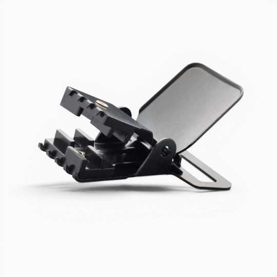 A black plastic Jessup clip by Arcade Belts, featuring a toothed jaw and a flat, rectangular back—built for durability in suspender hardware—angled open against a plain white background.