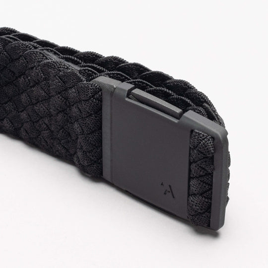 A close-up of the Arcade Belts Futureweave, a black woven webbing belt with a matte black rectangular buckle and subtle arrow logo, shown on a plain white background.