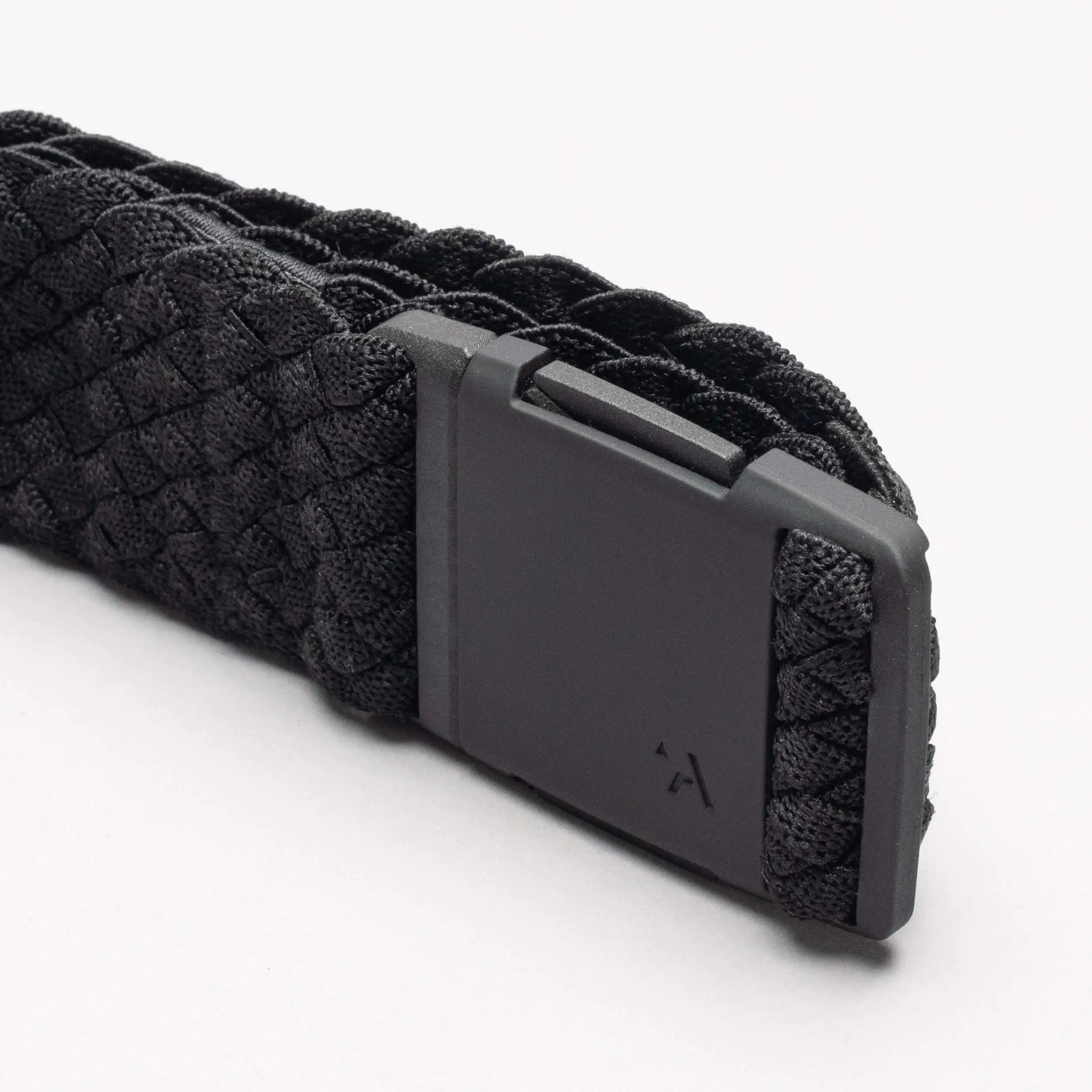 A close-up of the Arcade Belts Futureweave, a black woven webbing belt with a matte black rectangular buckle and subtle arrow logo, shown on a plain white background.