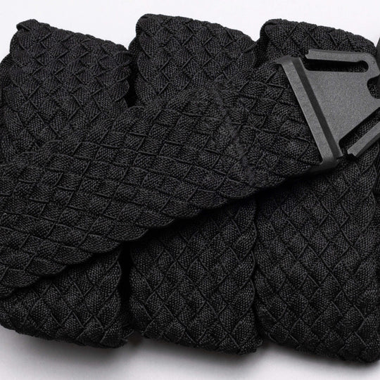 A close-up of the Arcade Belts Futureweave: a lightweight black belt featuring textured woven webbing and a matte black buckle, displayed neatly on a light background.