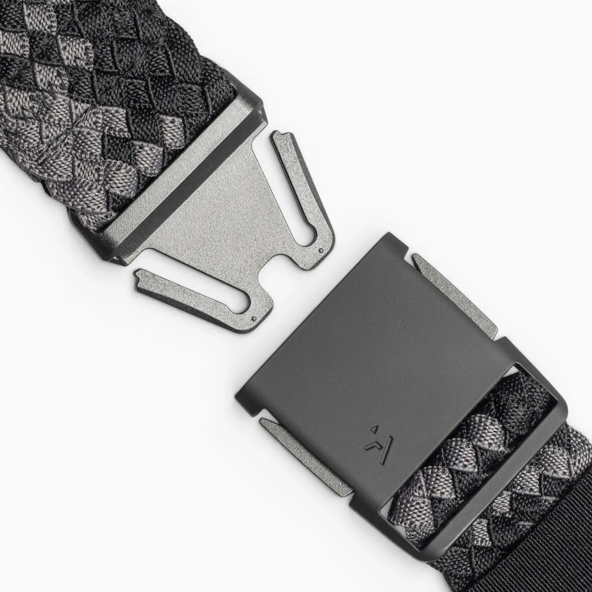 Close-up of the Arcade Belts Futureweave, a black and gray woven webbing belt with a rectangular metal buckle, shown with its two clasped ends separated on a white background.