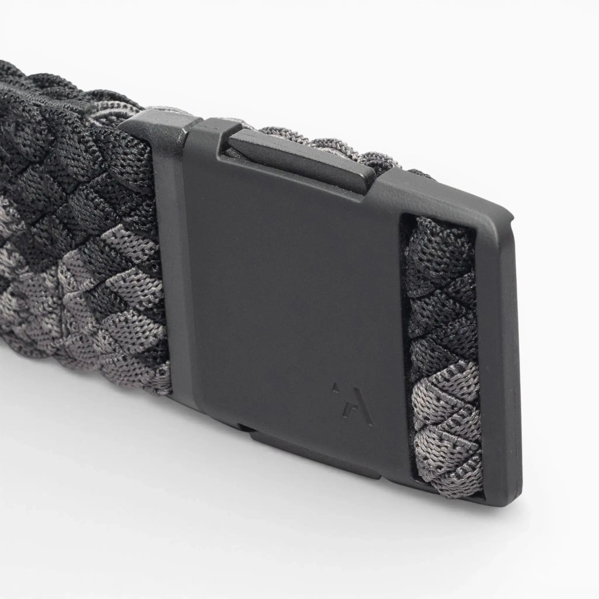 A close-up of the Arcade Belts Futureweave, a black and gray woven webbing paracord belt featuring a matte black rectangular buckle, set against a white background.