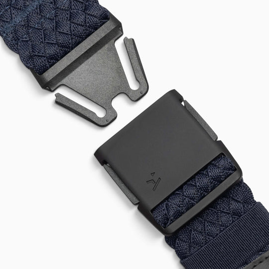 Close-up of the Arcade Belts Futureweave—a navy blue, lightweight belt made from durable woven webbing, shown unfastened with a matte black buckle against a white background.