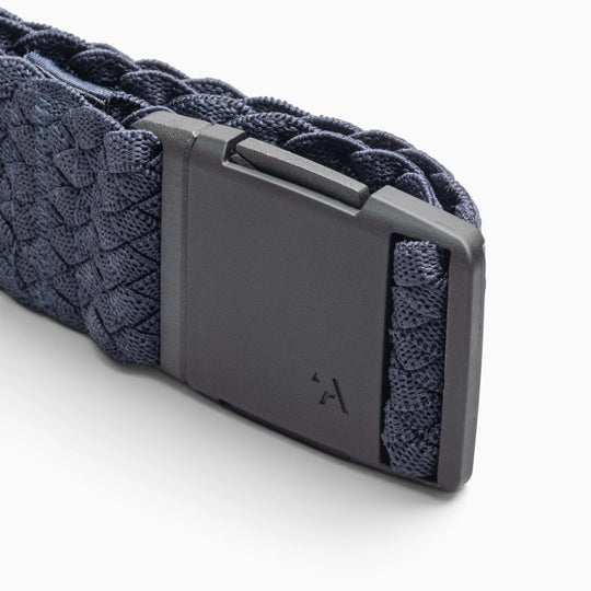 A close-up of the Arcade Belts Futureweave, a dark blue braided fabric belt made from woven webbing and featuring a matte black rectangular buckle, shown on a white background.
