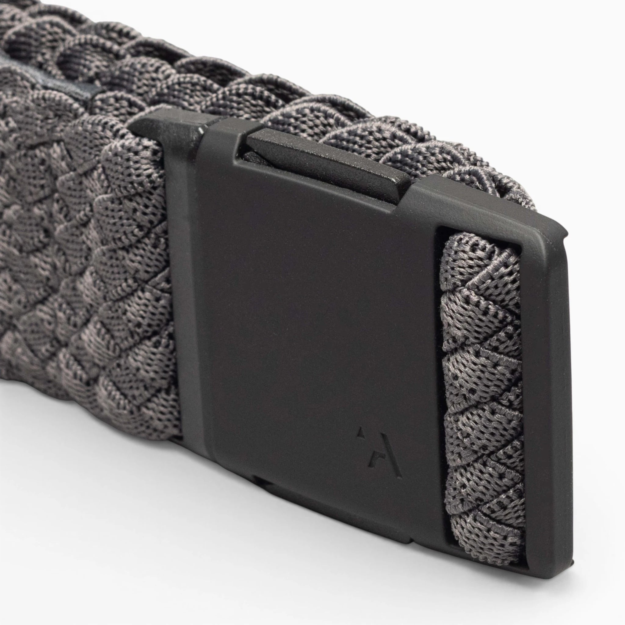 Close-up of the Arcade Belts Futureweave: a gray woven webbing belt with a matte black rectangular buckle, subtly engraved with the brand’s logo.