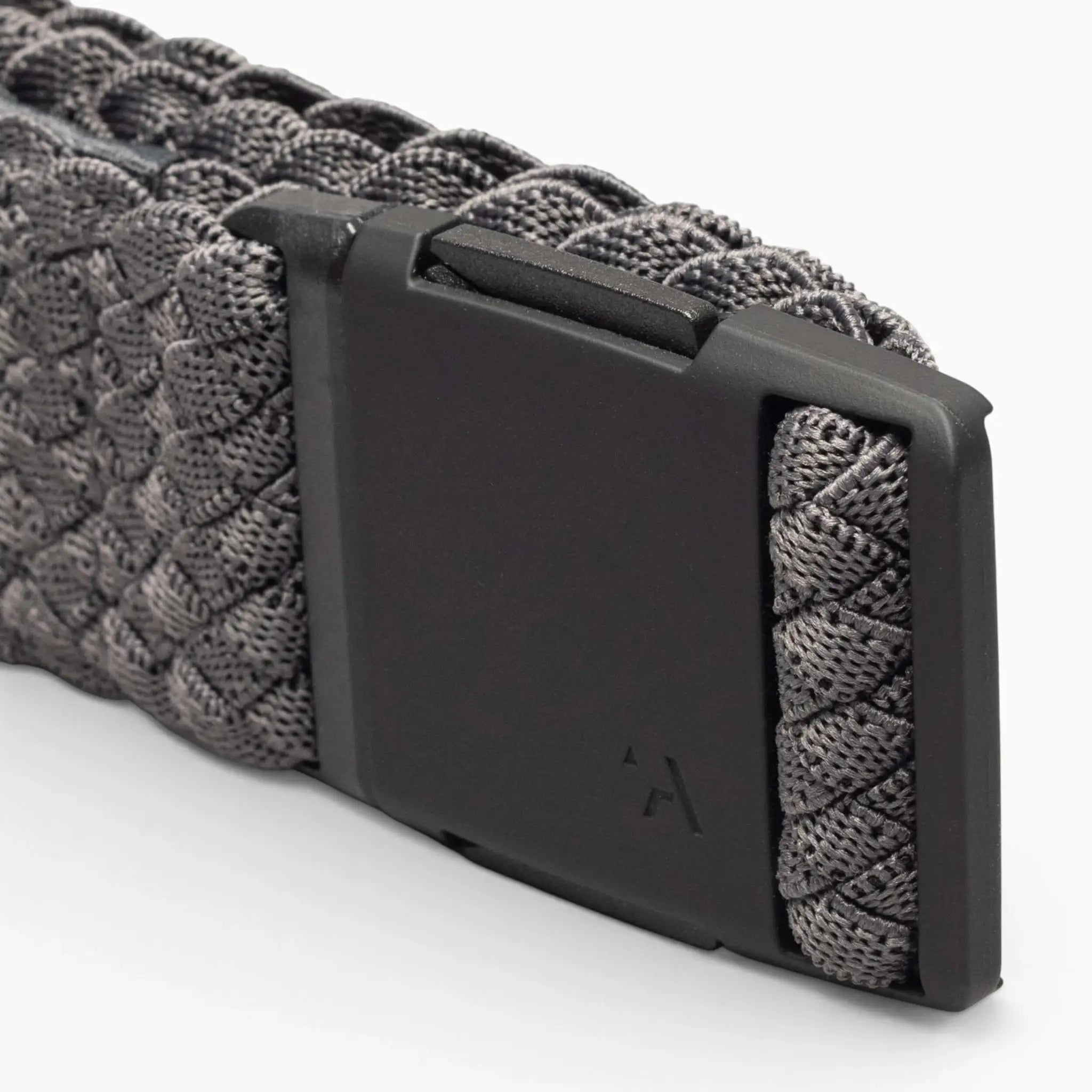 Close-up of the Arcade Belts Futureweave: a gray woven webbing belt with a matte black rectangular buckle, subtly engraved with the brand’s logo.