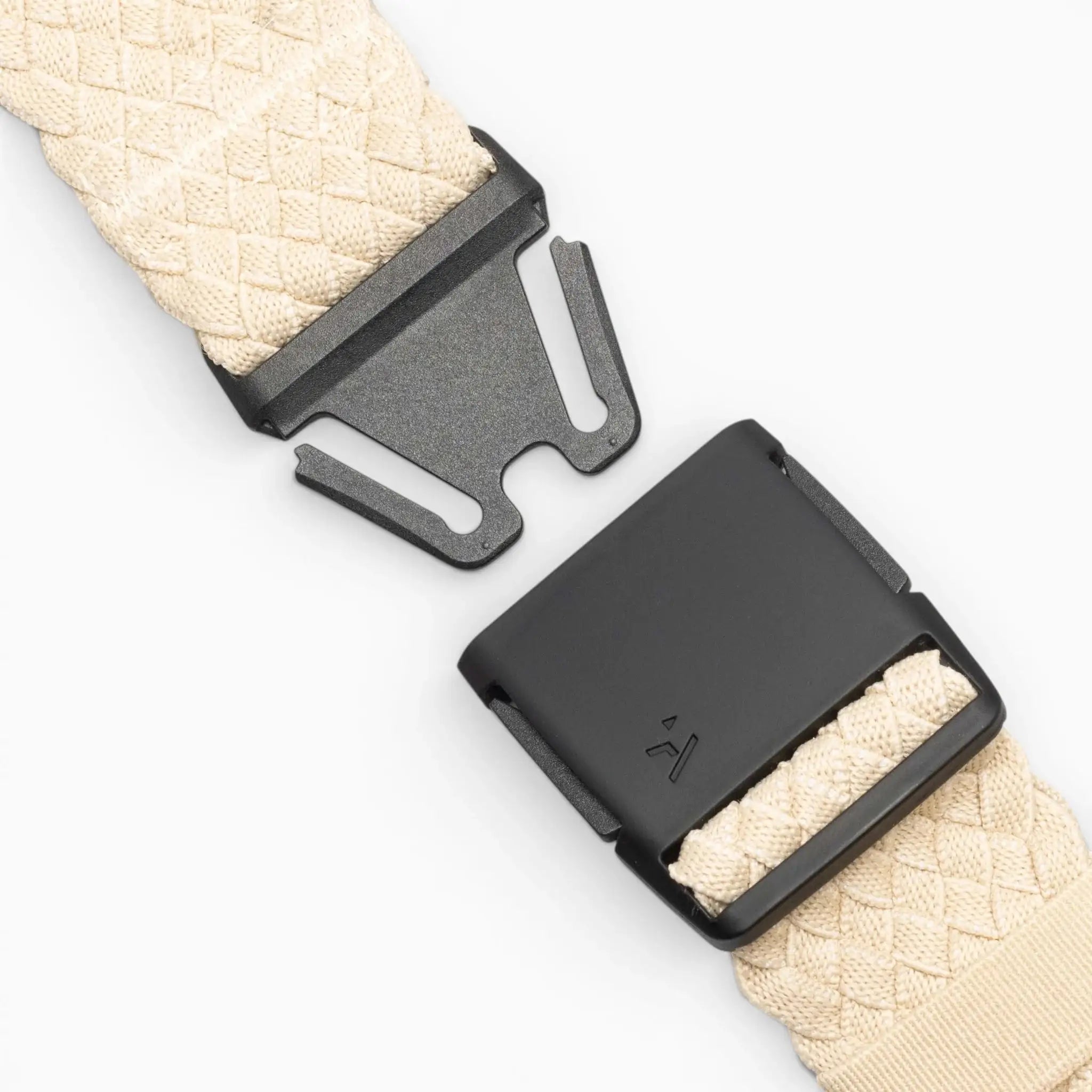 Close-up of the Futureweave belt by Arcade Belts in beige, featuring a black metal buckle and clasp, displayed unfastened on a light gray background.