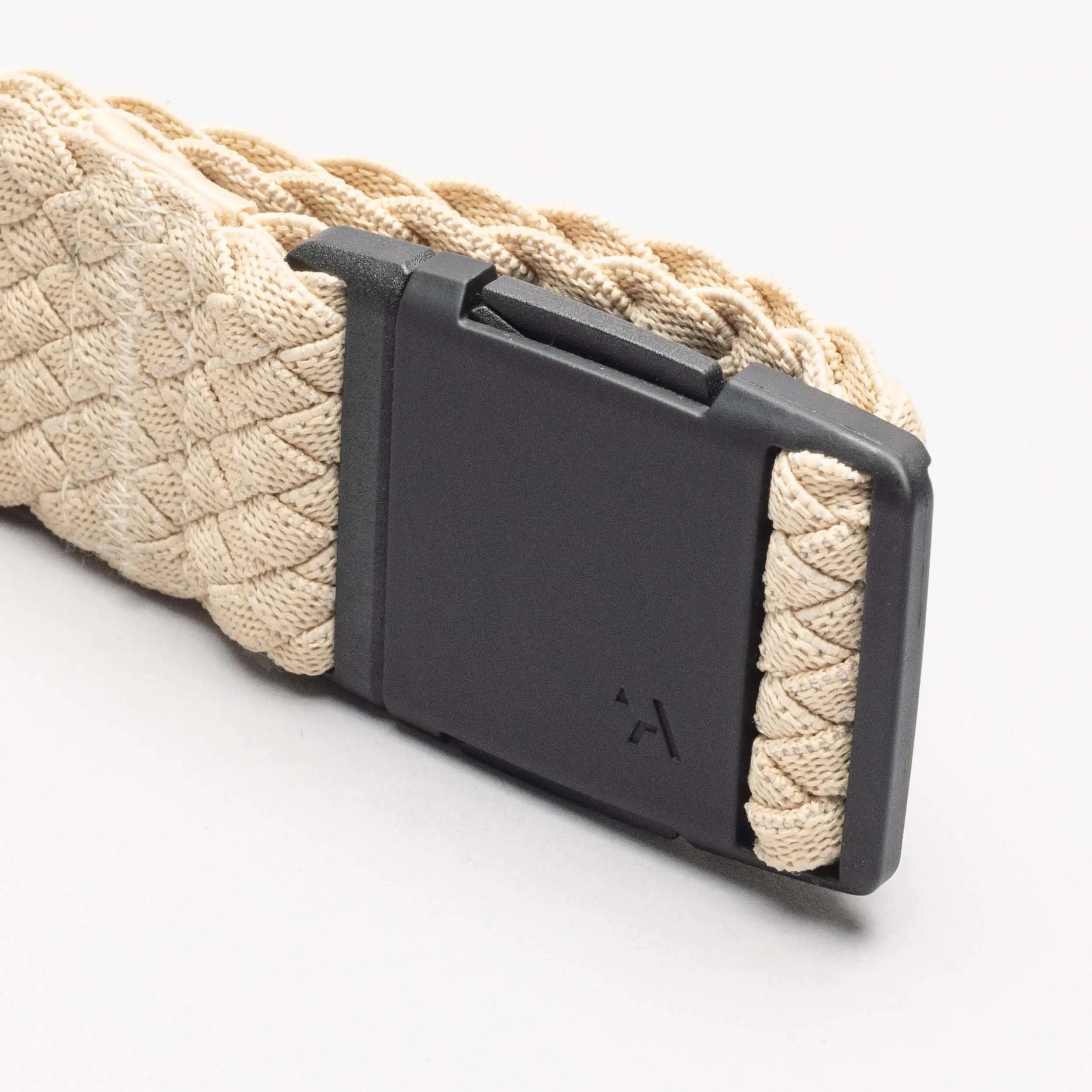 A close-up of the beige Arcade Belts Futureweave, a woven low profile belt with a matte black rectangular buckle, displayed on a plain white background—ideal for fans of Arcade Belts.