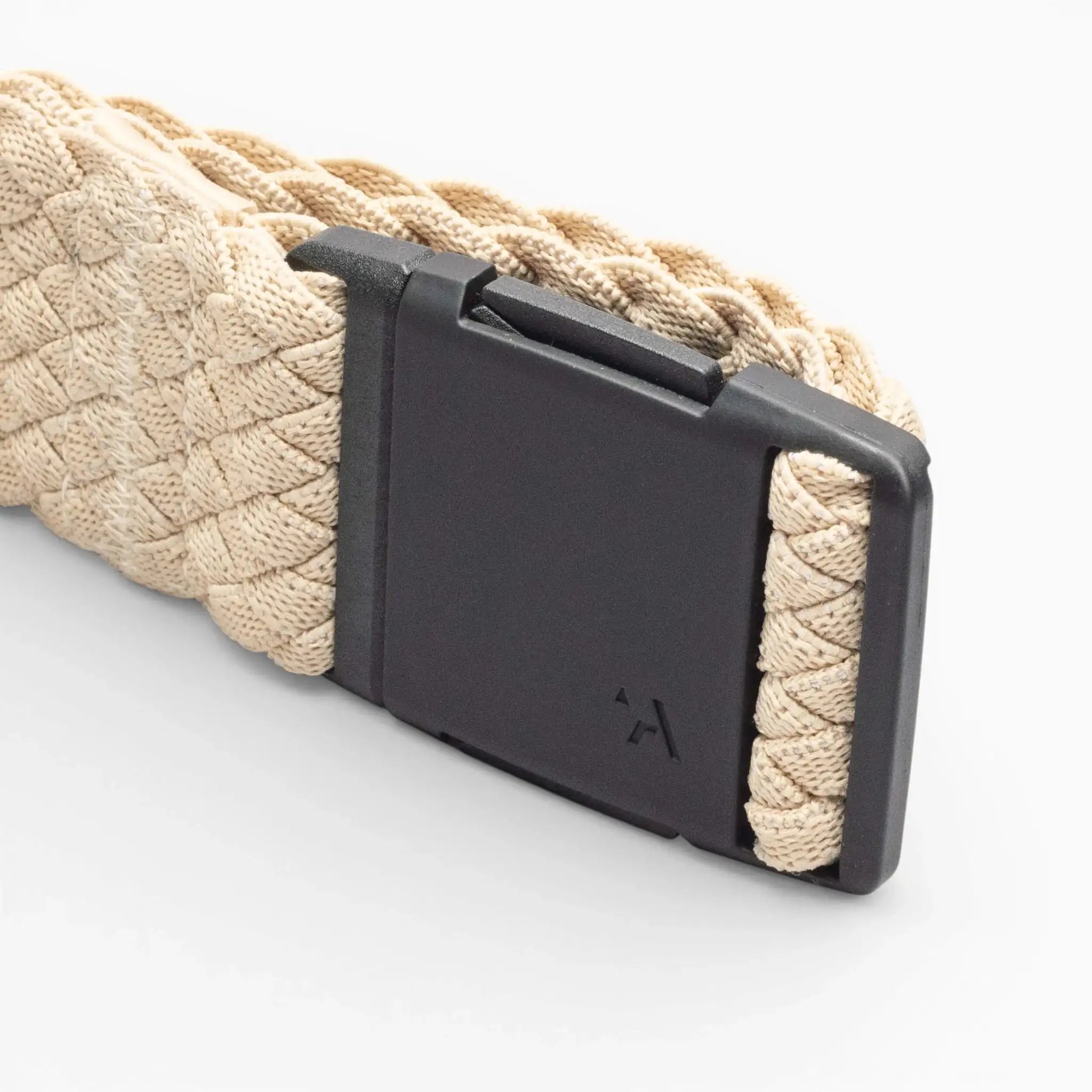 A close-up of the beige Arcade Belts Futureweave, a woven low profile belt with a matte black rectangular buckle, displayed on a plain white background—ideal for fans of Arcade Belts.