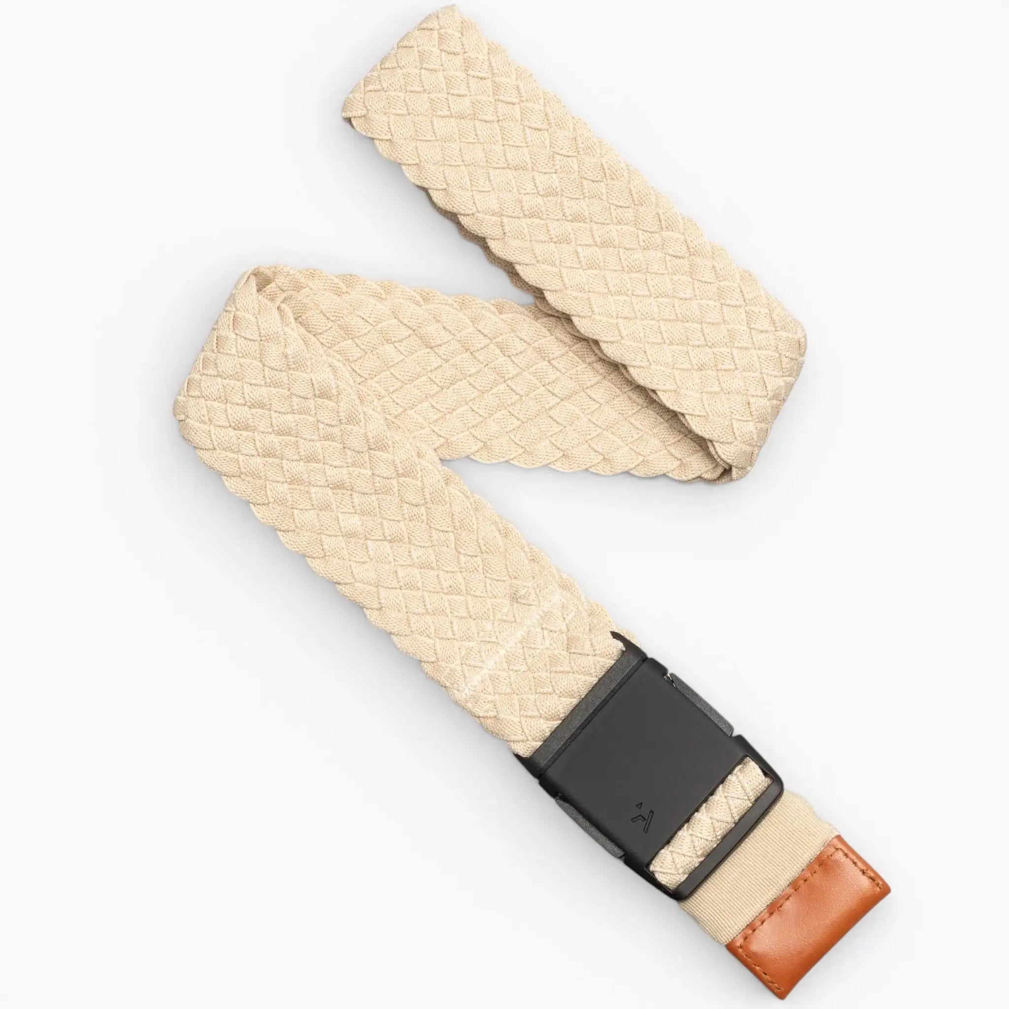 The Arcade Belts Futureweave is a beige stretch webbing belt with a diamond pattern, low-profile black buckle, and brown leather accent, shown on a white background.