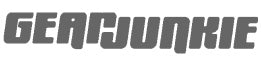 The word GEARJUNKIE in bold, rounded, uppercase gray letters, displayed on a white background—resembling the simplicity and style of a low profile belt with a sleek plastic buckle.