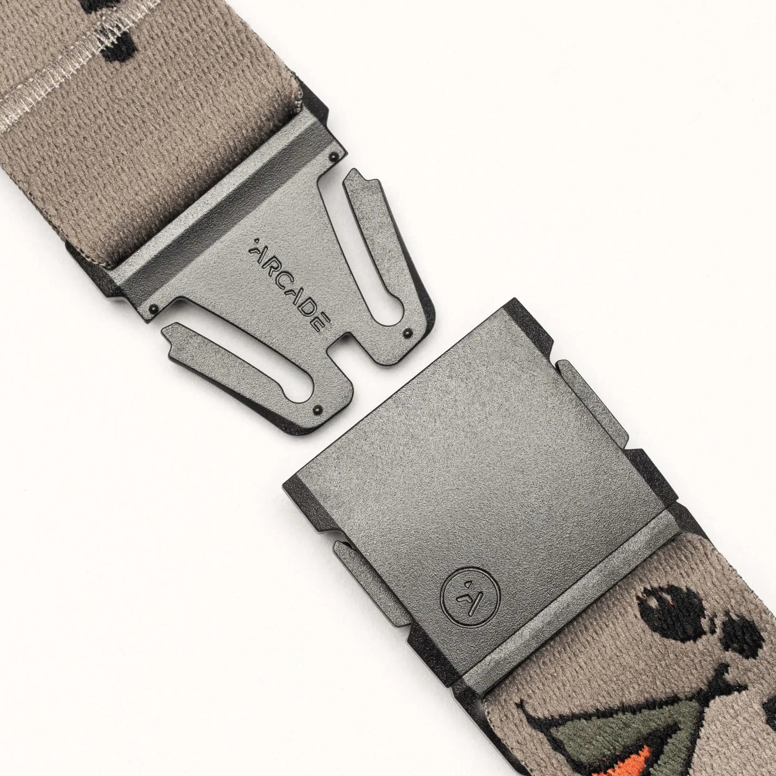 Close-up of the gray Get Outside hiking belt by Arcade Belts, featuring a metal buckle and a cartoon design with an orange beak and black accents—ideal for your next campfire or Big City Mountaineers adventure.