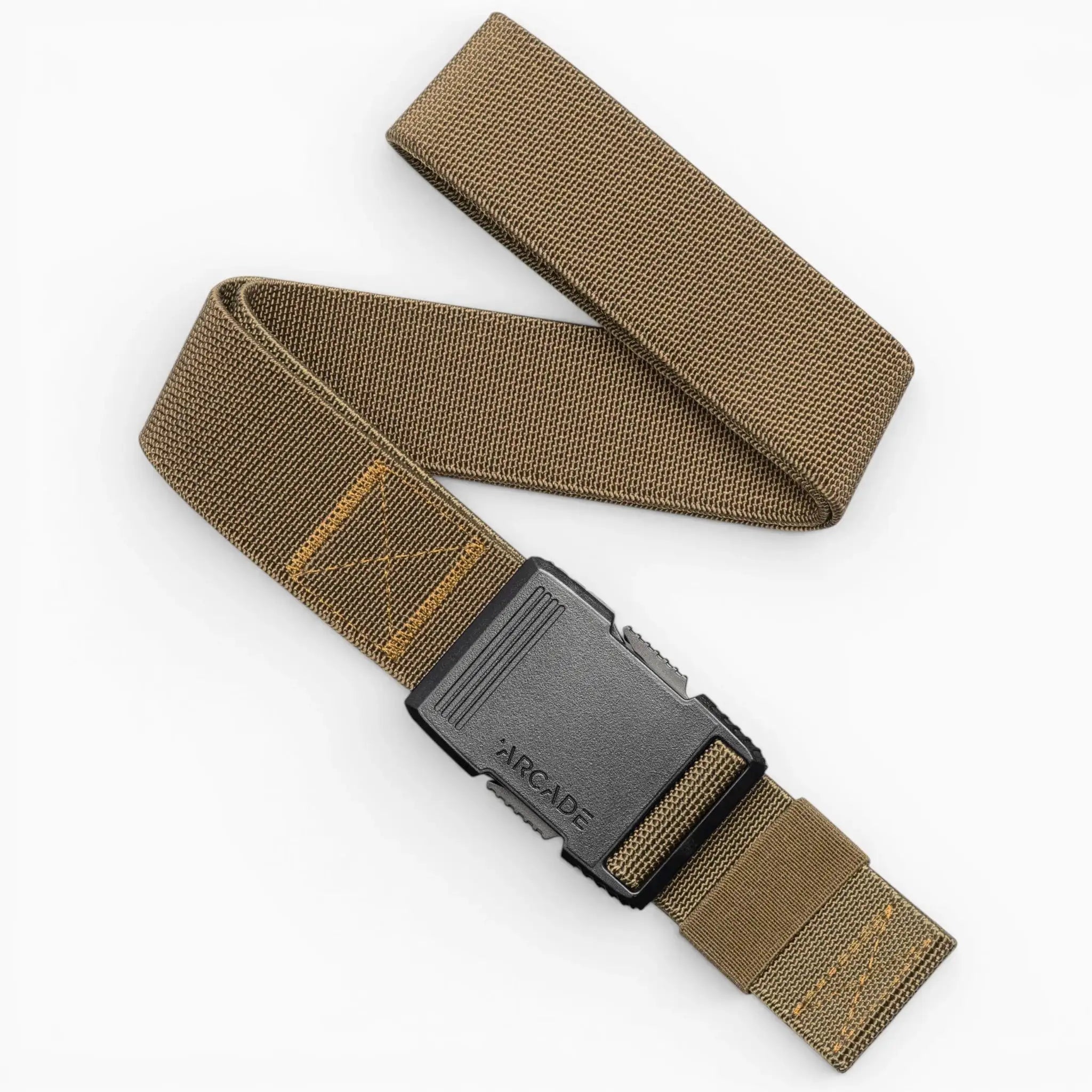 The Arcade Belts Hardware is a brown elastic travel belt with yellow stitching and a black plastic buckle, shown coiled on a white background.