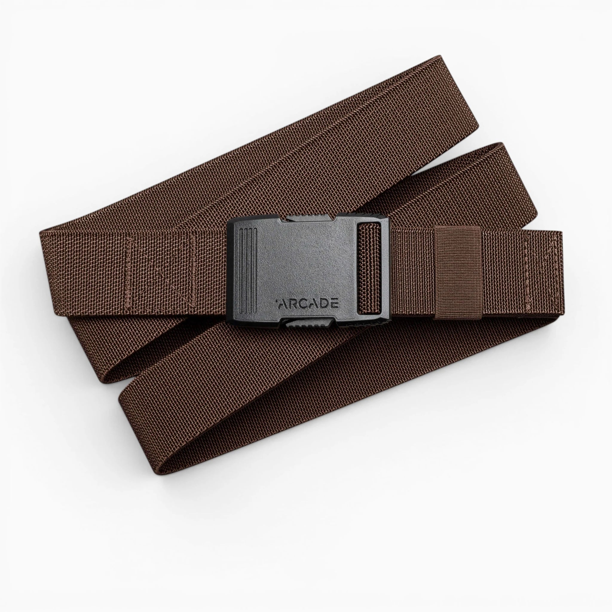 The Arcade Belts Hardware is a brown stretch webbing belt with a low profile and a black rectangular buckle labeled ARCADE, shown coiled on a white background.