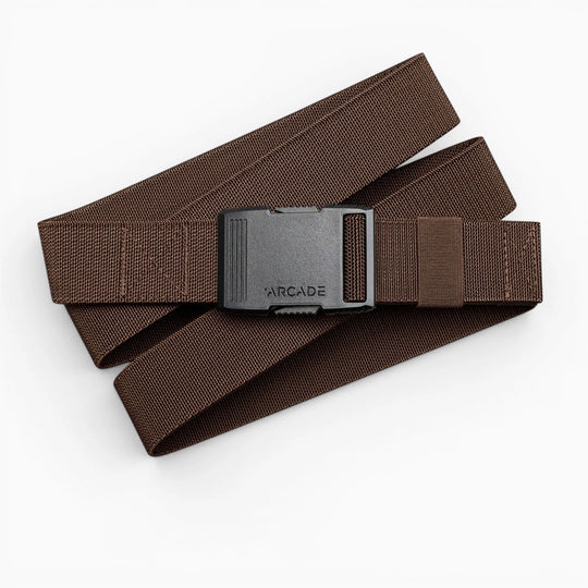 The Arcade Belts Hardware is a brown stretch webbing belt with a low profile and a black rectangular buckle labeled ARCADE, shown coiled on a white background.