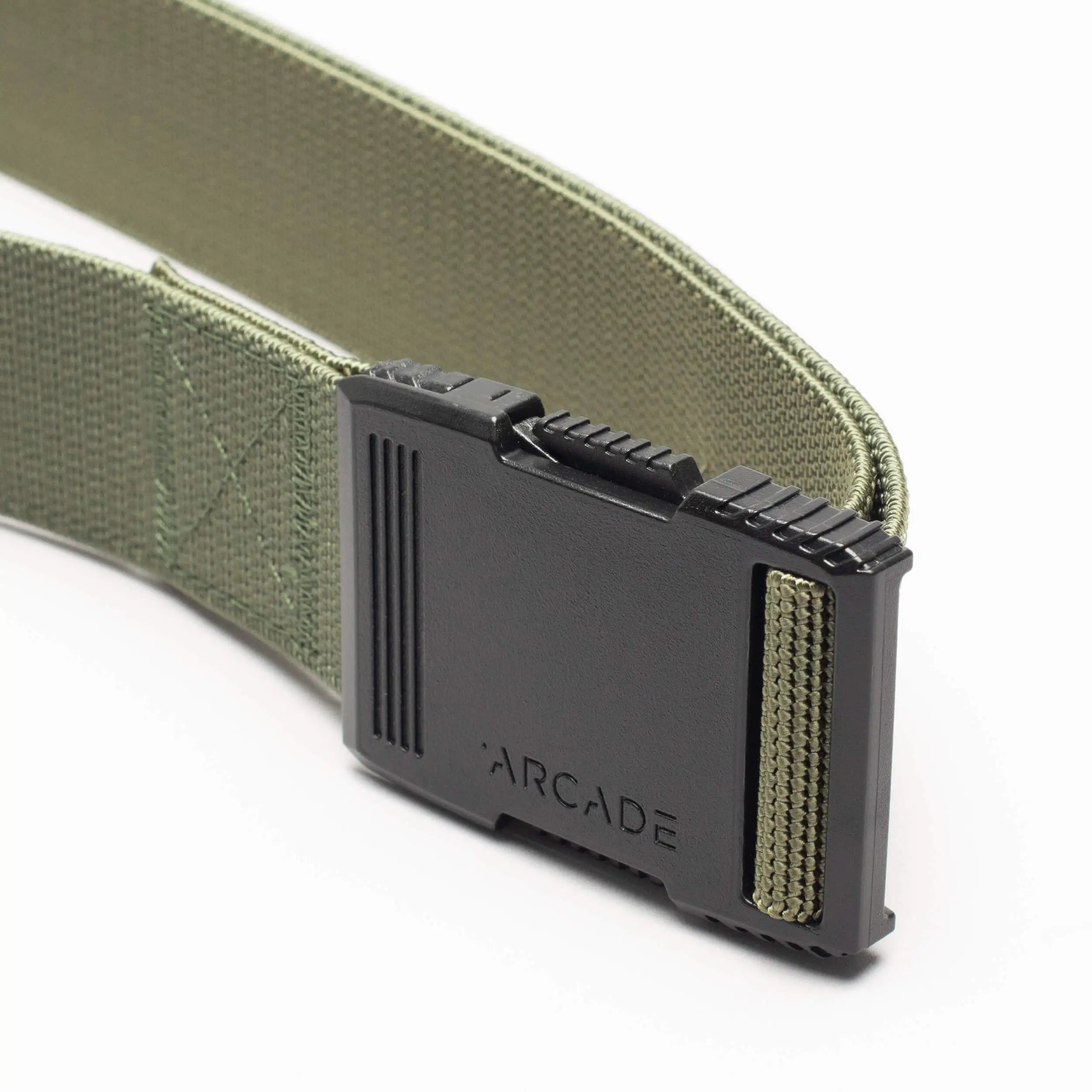 A close-up of the olive green Arcade Belts Hardware with a low-profile, black plastic buckle featuring ridged edges and ARCADE engraved on it, set against a plain white background.