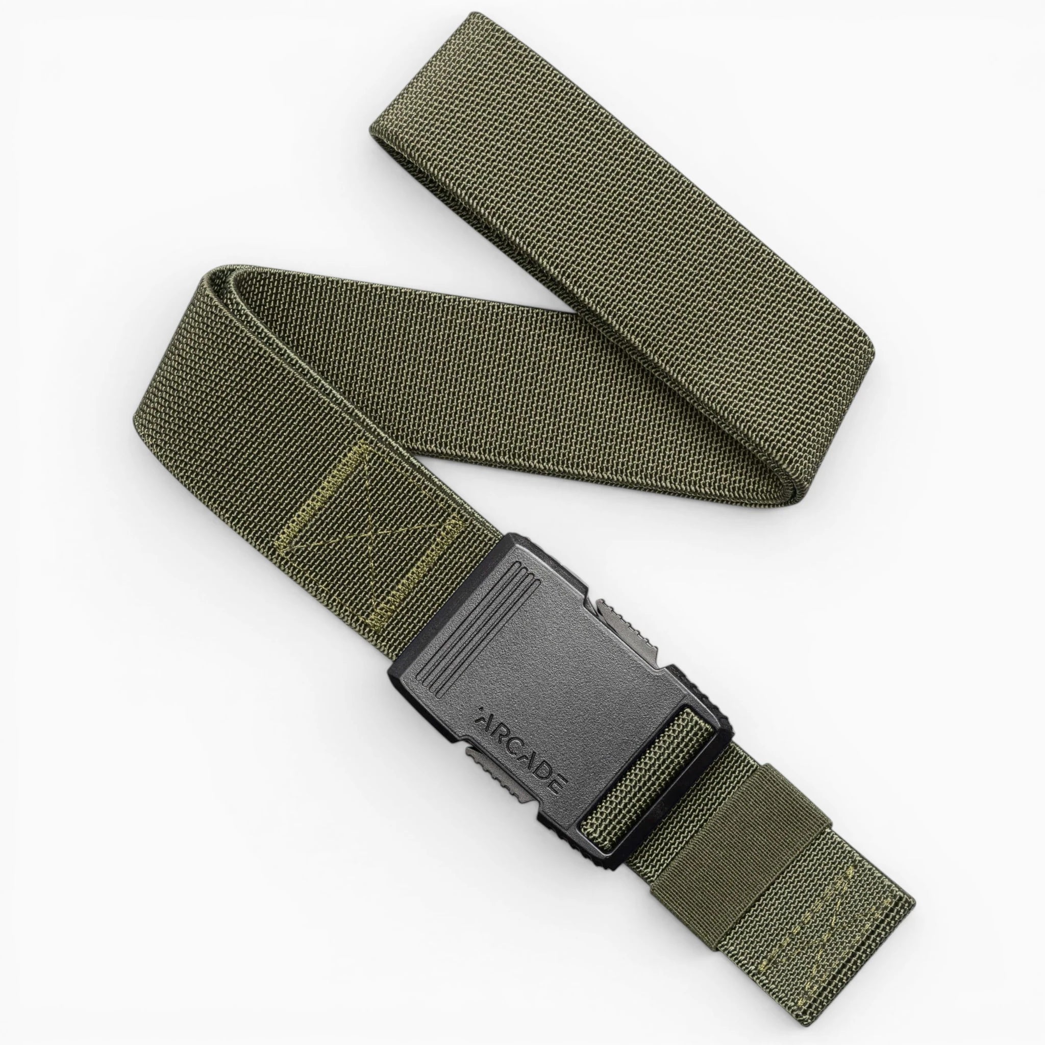 The Arcade Belts Hardware is a green elastic stretch belt with a black plastic buckle embossed with ARCADE, shown coiled in an S shape on a white background—a perfect travel belt thanks to its flexible stretch webbing design.