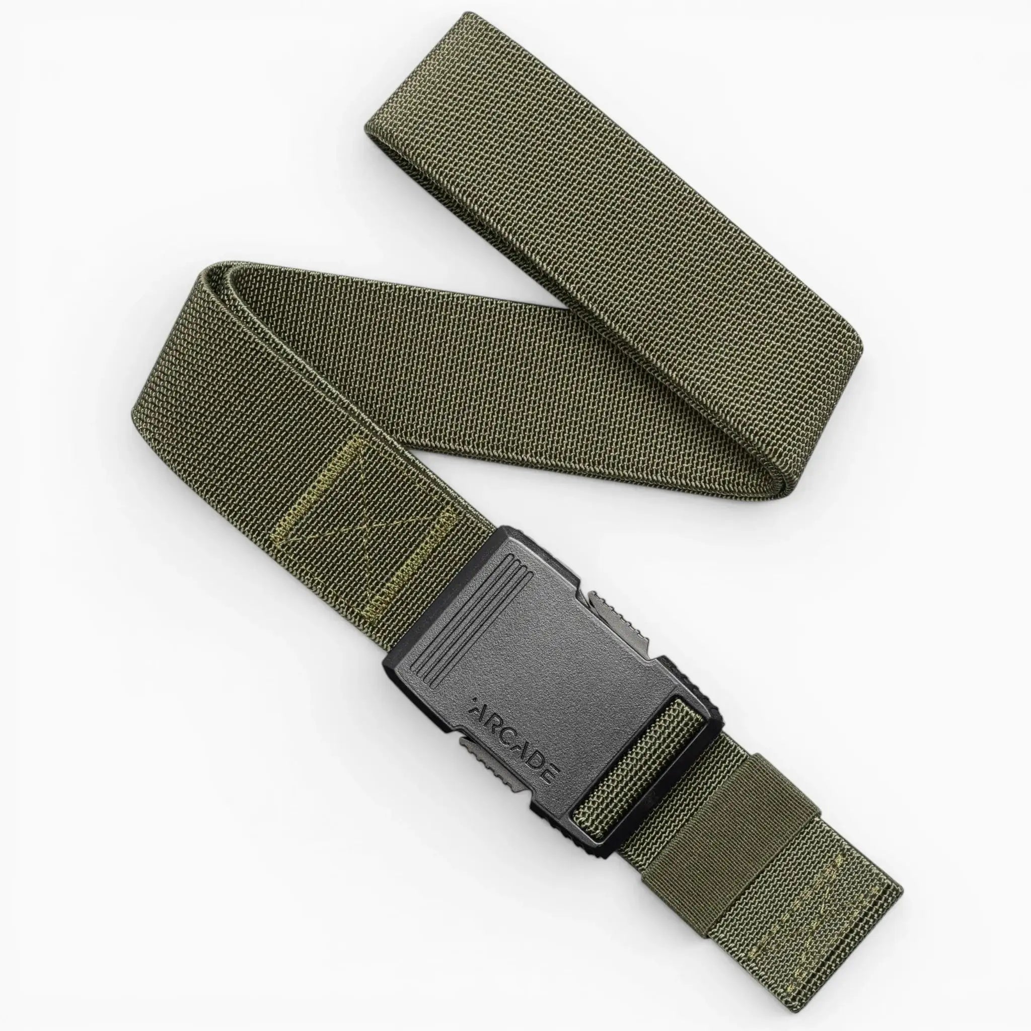 The Arcade Belts Hardware is a green elastic stretch belt with a black plastic buckle embossed with ARCADE, shown coiled in an S shape on a white background—a perfect travel belt thanks to its flexible stretch webbing design.