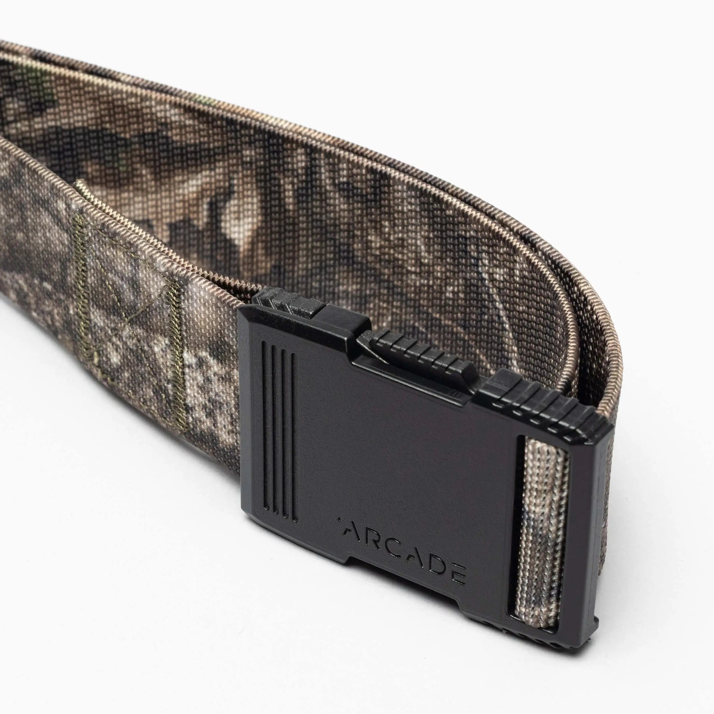 A close-up of the Arcade Belts Hardware, a camouflage-patterned belt with a low profile design and black buckle engraved with ARCADE, displayed on a white background.