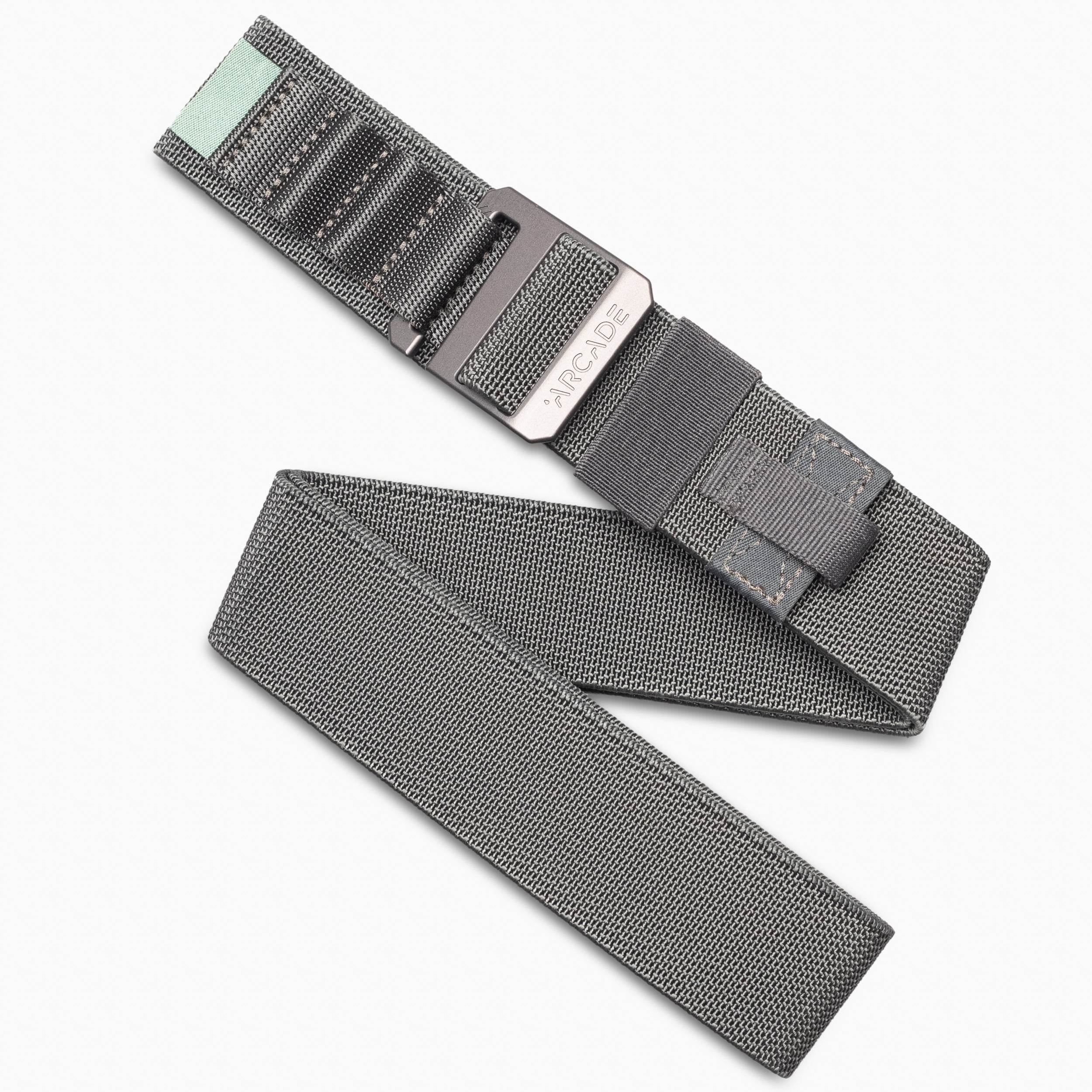 The Arcade Belts Hardware Alu Long Kit features gray woven stretch webbing, a black metal buckle, black stitching, and a mint green accent on one end—ideal for travel or everyday wear. Shown on a white background.