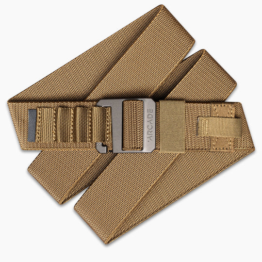 The Arcade Belts Hardware Alu is a tan, heavy-duty nylon belt with a rectangular plastic buckle, shown folded on a white background—ideal for anyone needing a durable travel belt.