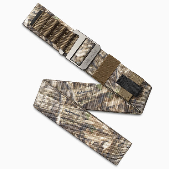 The Arcade Belts Realtree Kit is a low profile belt featuring a camouflage pattern, stretch webbing, black loop, and brown accent, shown laid flat with one end folded to display its length and design.