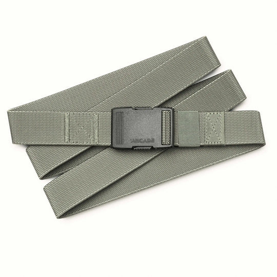 The Arcade Belts Hardware is a gray fabric belt with a black plastic buckle, laid flat on a white background. Adjustable and minimalist, it's designed for durability and superior strength.