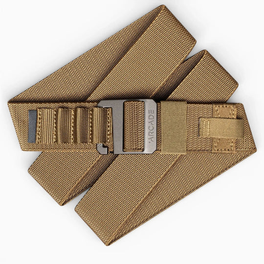 The Arcade Belts Hardware Alu is a tan, heavy-duty nylon belt with a rectangular plastic buckle, shown folded on a white background—ideal for anyone needing a durable travel belt.