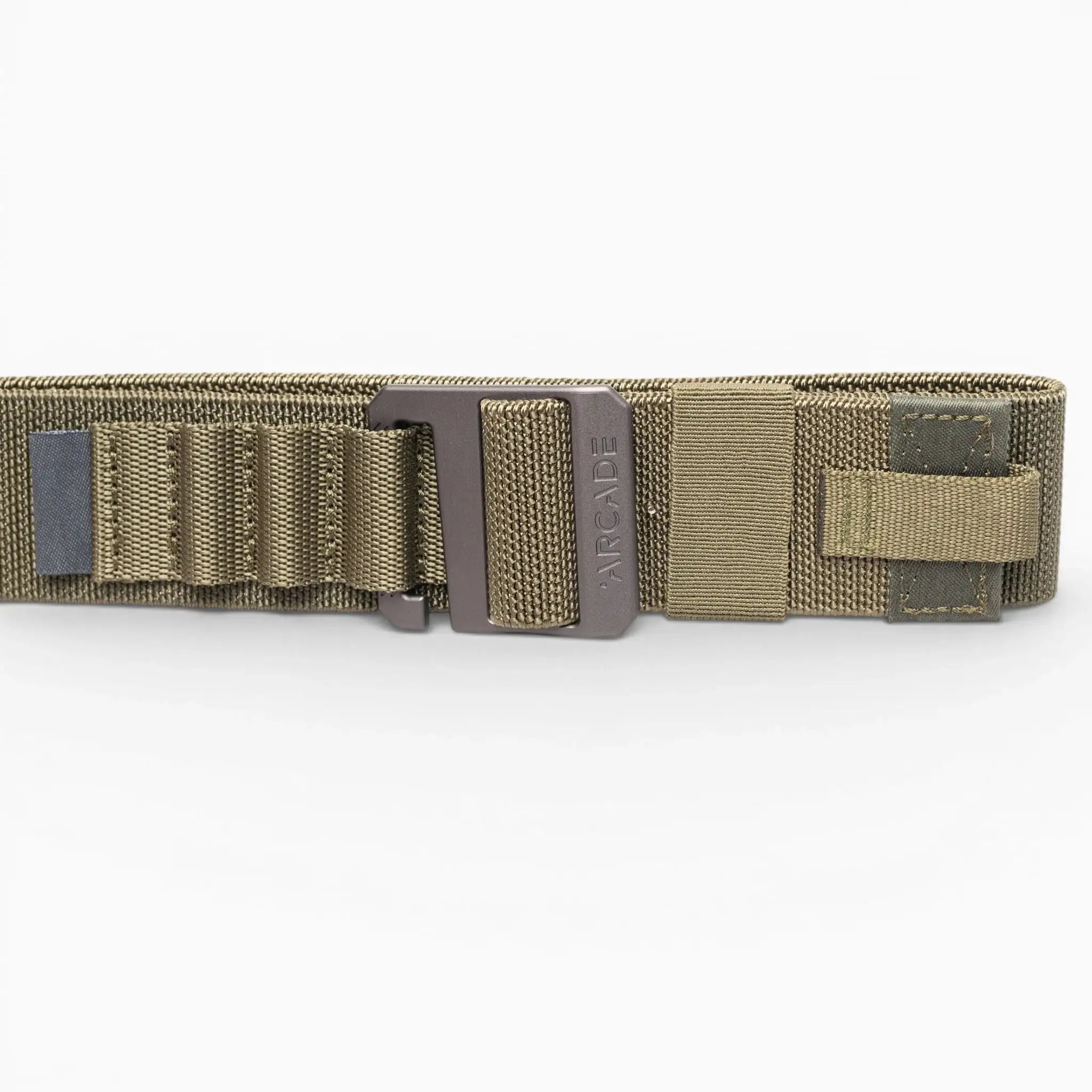 A close-up of the olive green Arcade Belts Hardware Alu tactical belt with a metal buckle, reinforced stitching, webbing loops, and Velcro strap. This low-profile belt offers durability and comfort against a white background.