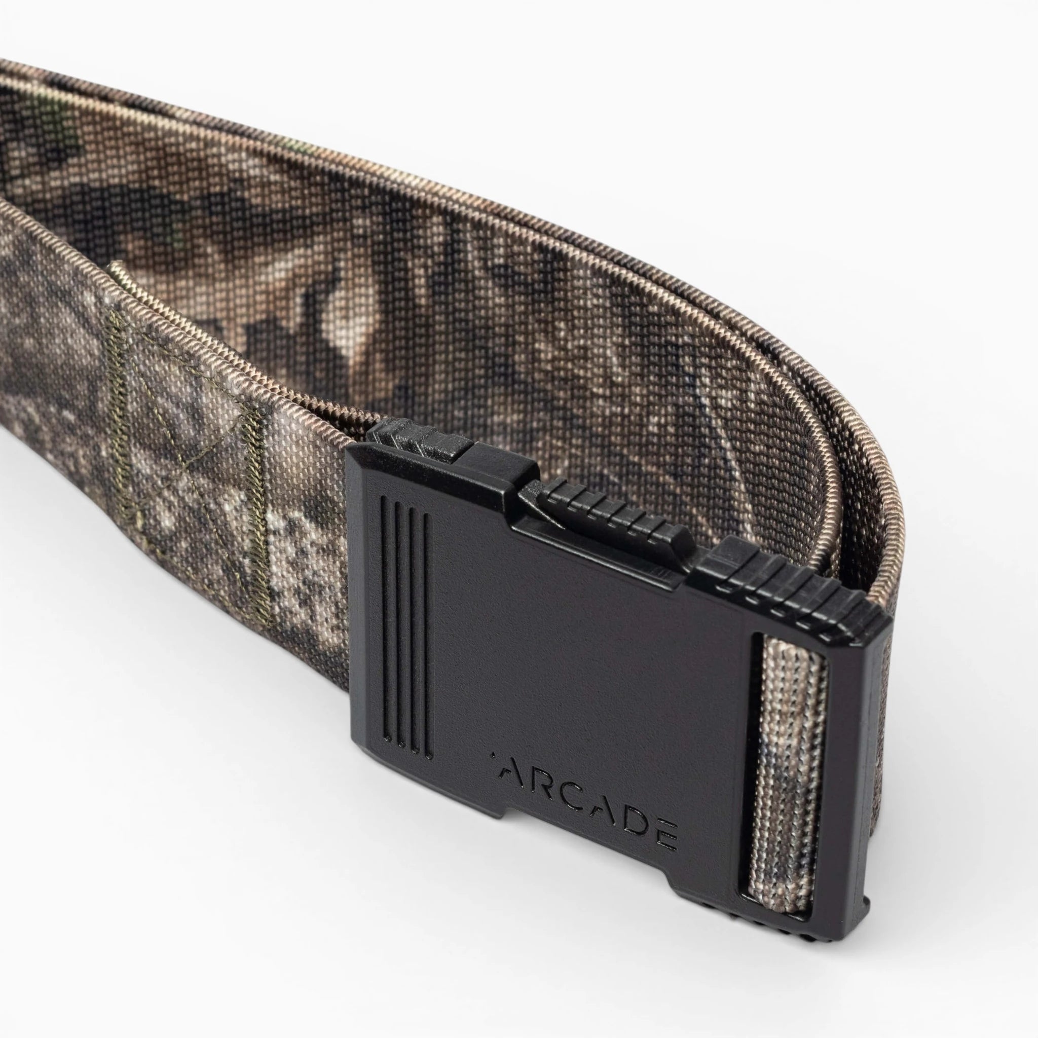 A close-up of the Arcade Belts Hardware, a camouflage-patterned belt with a low profile design and black buckle engraved with ARCADE, displayed on a white background.