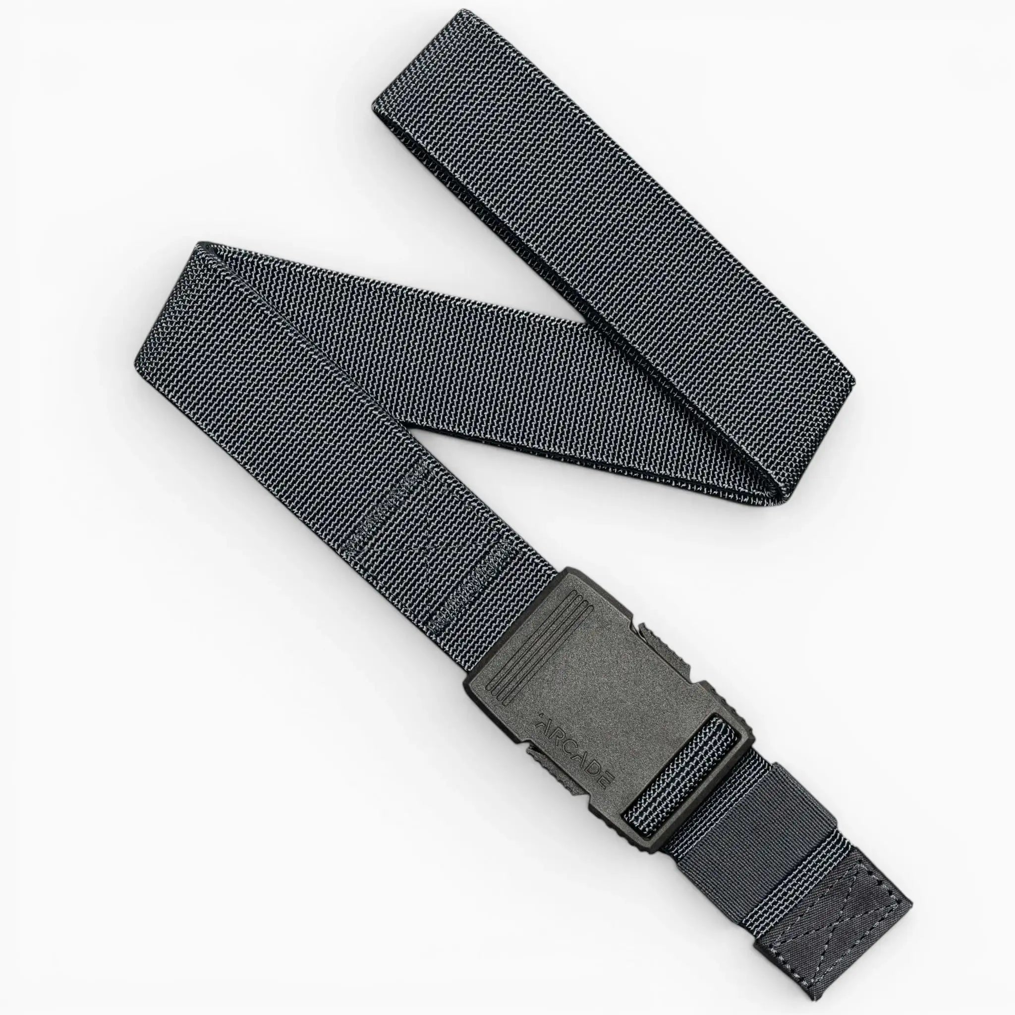 The Arcade Belts Hardware in Charcoal features a durable nylon strap and sturdy plastic buckle, arranged here in a loose zigzag on a white background, providing superior strength for carrying essential tools or gear.