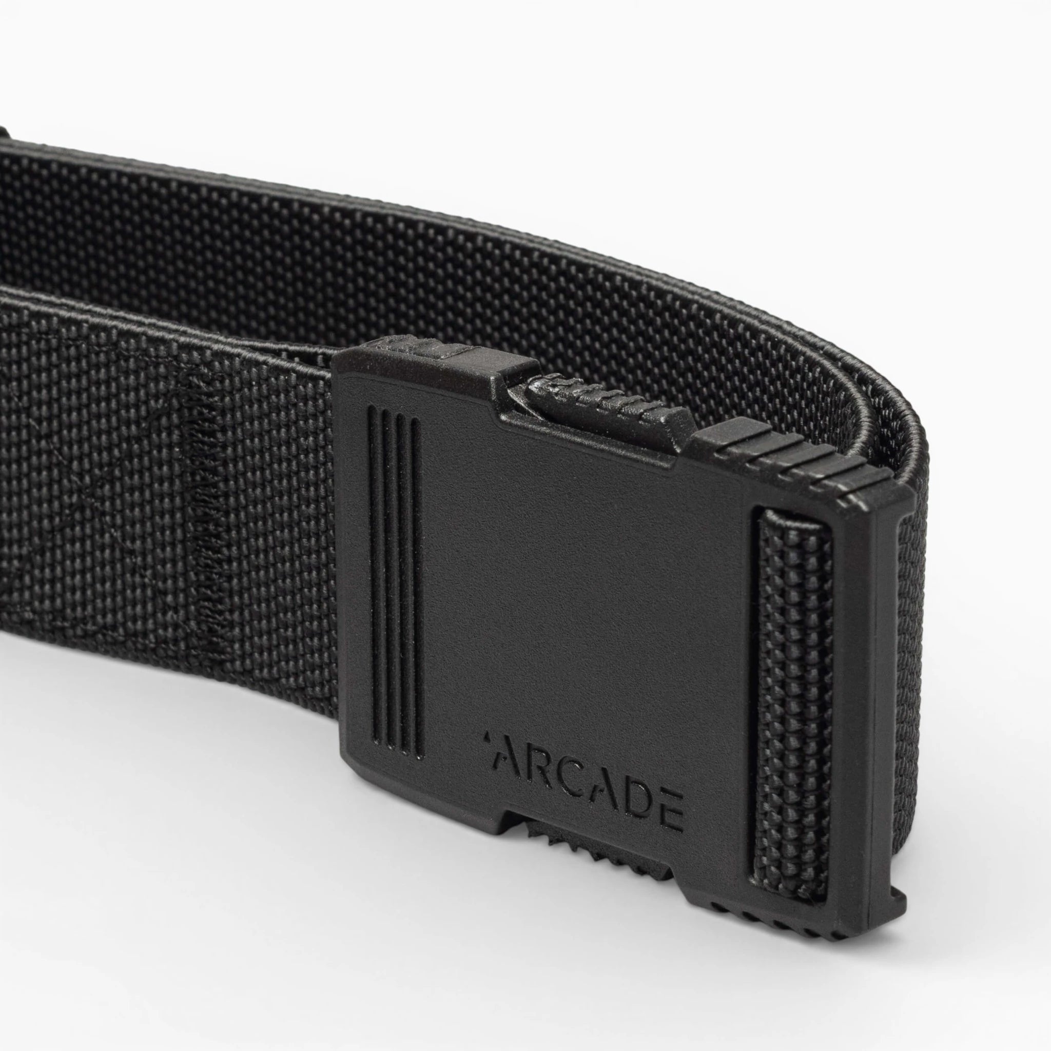 Close-up of the Arcade Belts Hardware belt with a rectangular plastic buckle and ARCADE embossed on it, highlighting its superior strength against a plain light background.
