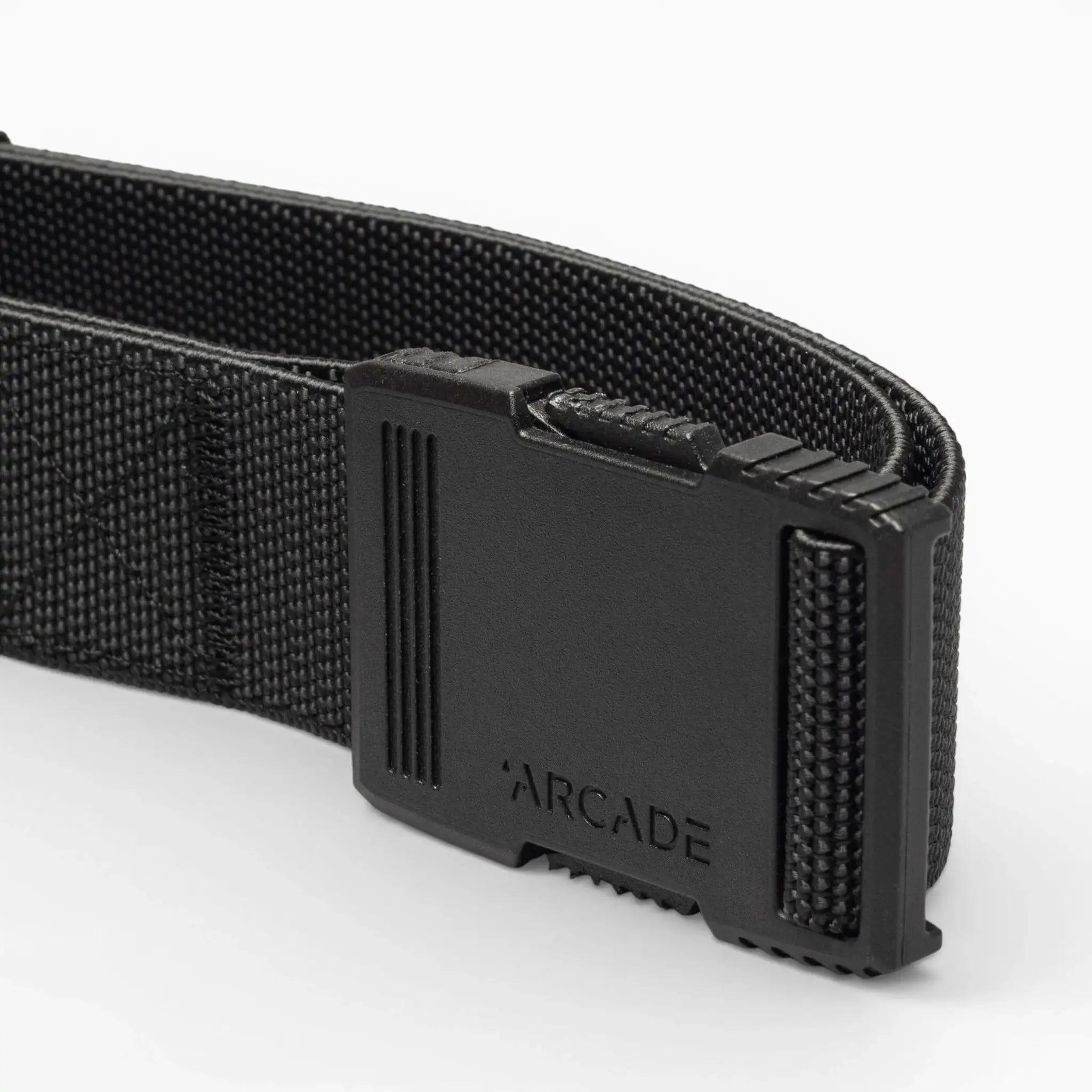 Close-up of the Arcade Belts Hardware belt with a rectangular plastic buckle and ARCADE embossed on it, highlighting its superior strength against a plain light background.