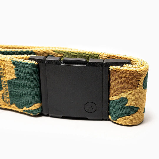 A close-up of the Arcade Belts High Fives Duck Camo, a camo-patterned low profile belt in shades of green and tan with a rectangular black buckle, shown against a white background.