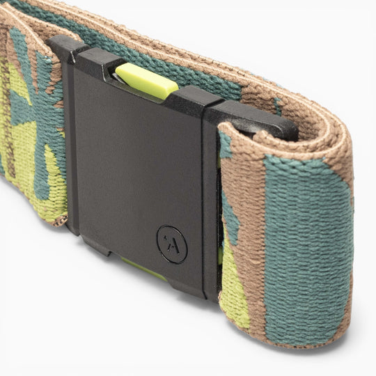 A close-up of the Arcade Belts Inkstorm, a woven fabric belt featuring a green, tan, and brown camouflage pattern and a black rectangular A2 buckle, crafted from performance stretch webbing for enhanced freedom of movement.