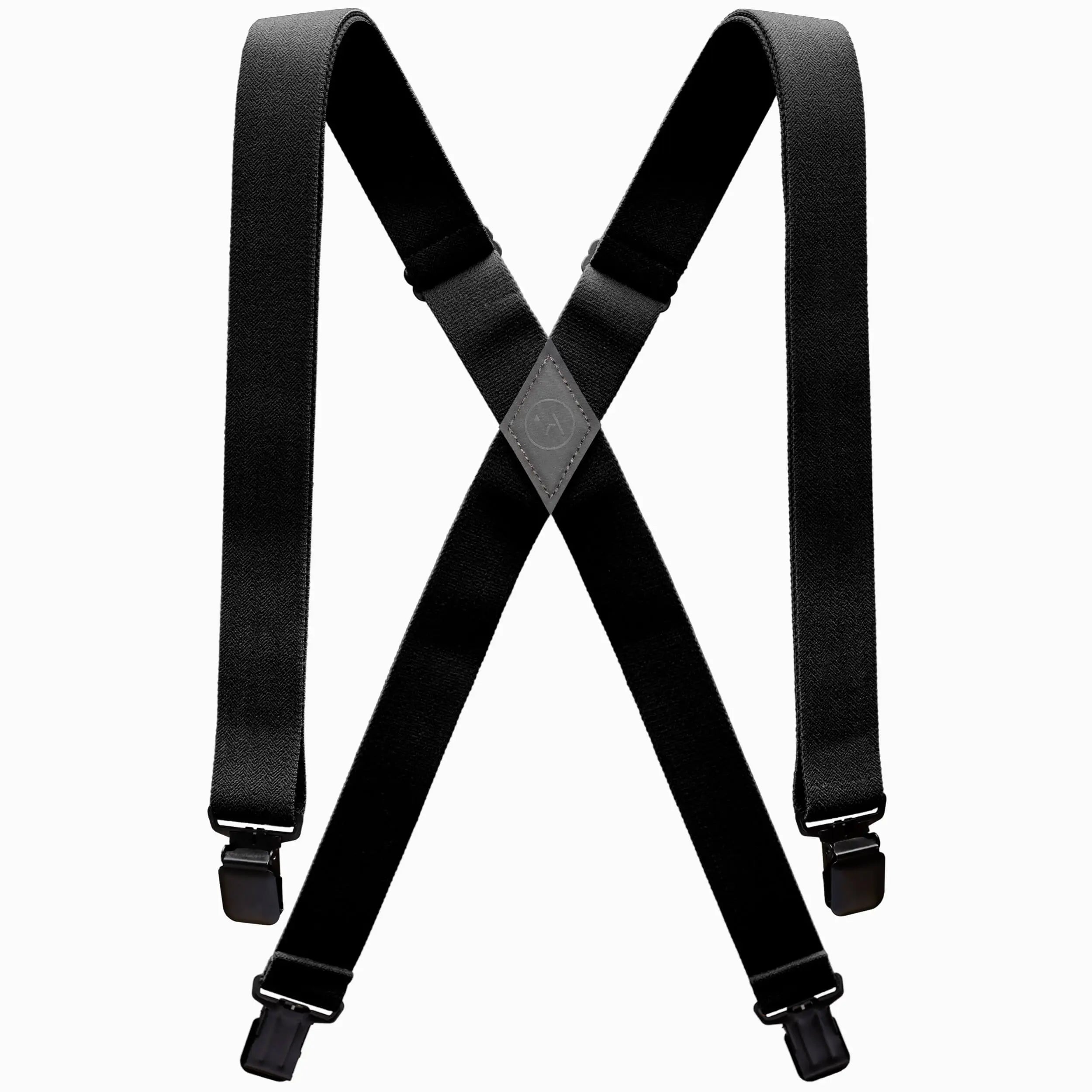 The Jessup by Arcade Belts is a pair of black suspenders with adjustable straps and metal clips, designed in an X shape and inspired by Arcade’s signature style. Shown on a white background.