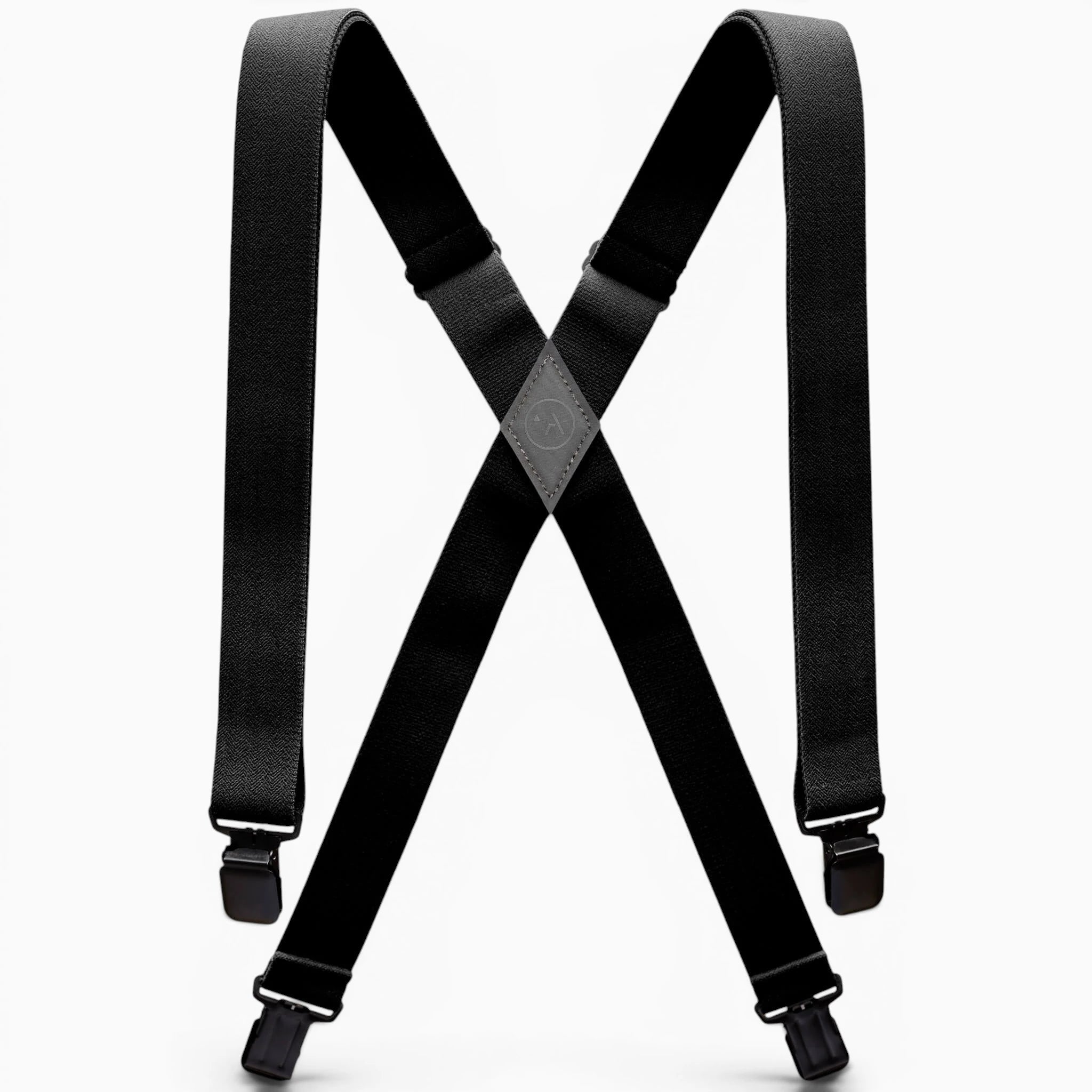 The Jessup by Arcade Belts is a pair of black suspenders with adjustable straps and metal clips, designed in an X shape and inspired by Arcade’s signature style. Shown on a white background.