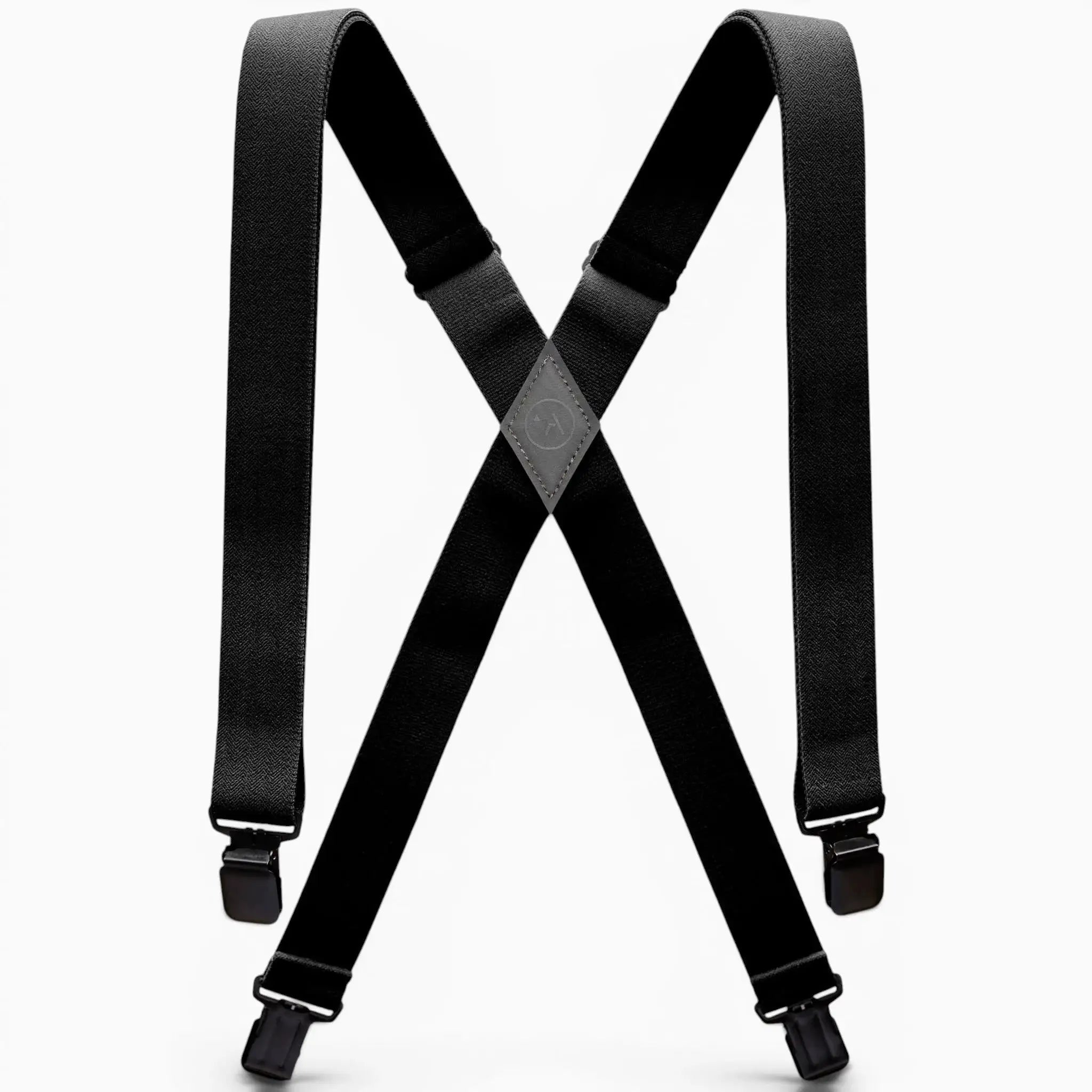 The Jessup by Arcade Belts is a pair of black suspenders with adjustable straps and metal clips, designed in an X shape and inspired by Arcade’s signature style. Shown on a white background.