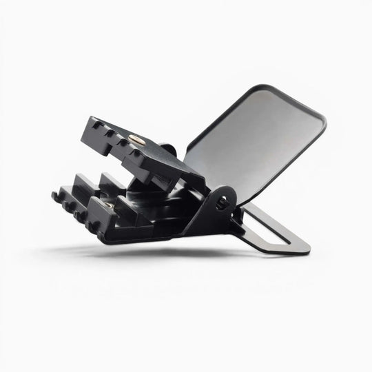 A black metal Jessup clip from Arcade Belts, featuring a hinged clamp and flat back, is displayed on a white background. This durable hardware is designed for heavy-duty suspenders, ensuring secure attachment and reliable support.