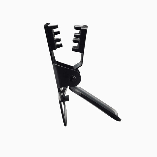 The Arcade Belts Jessup is a black plastic buckle tool with a hinged handle and notched clamp-like jaw, pictured upright against a white background.