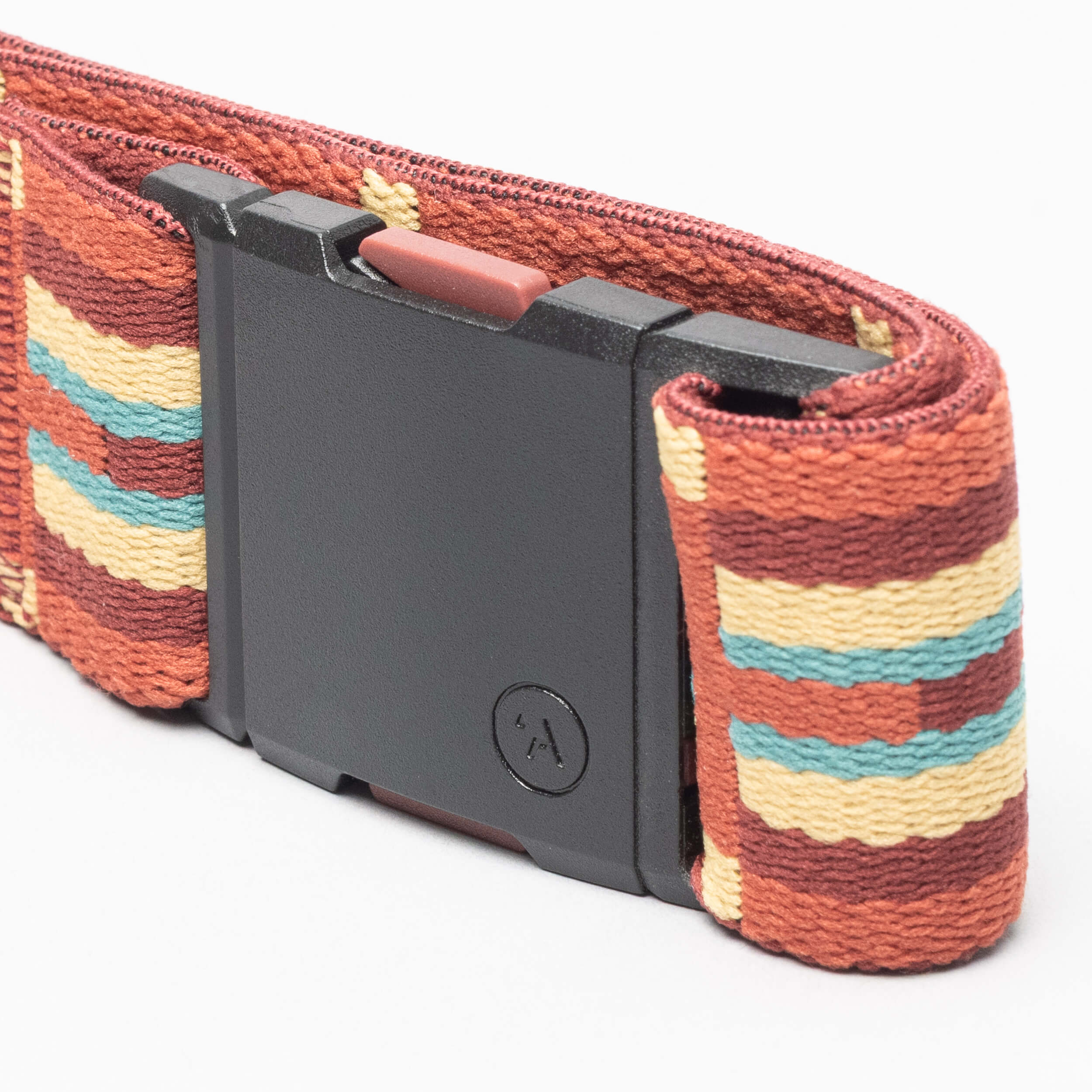 A close-up of the Arcade Belts Vernan Kee belt, featuring a black buckle and a woven design with geometric shapes and stripes in brown, rust, yellow, and teal inspired by Navajo rug patterns.
