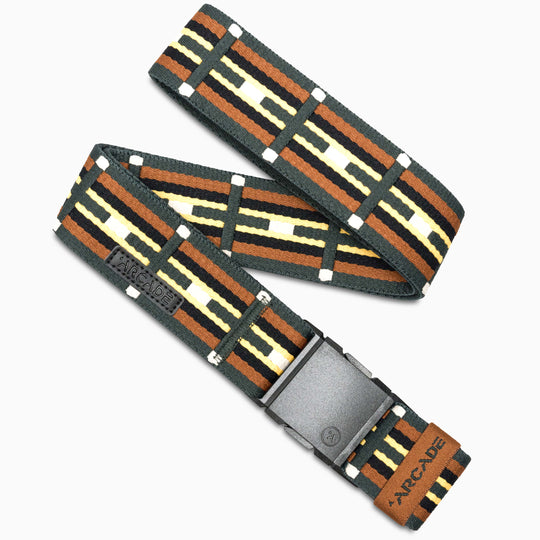 The Vernan Kee by Arcade Belts is a woven elastic stretch belt with a geometric brown, black, yellow, and white pattern, featuring a plastic buckle and leather patch—ideal for travel.